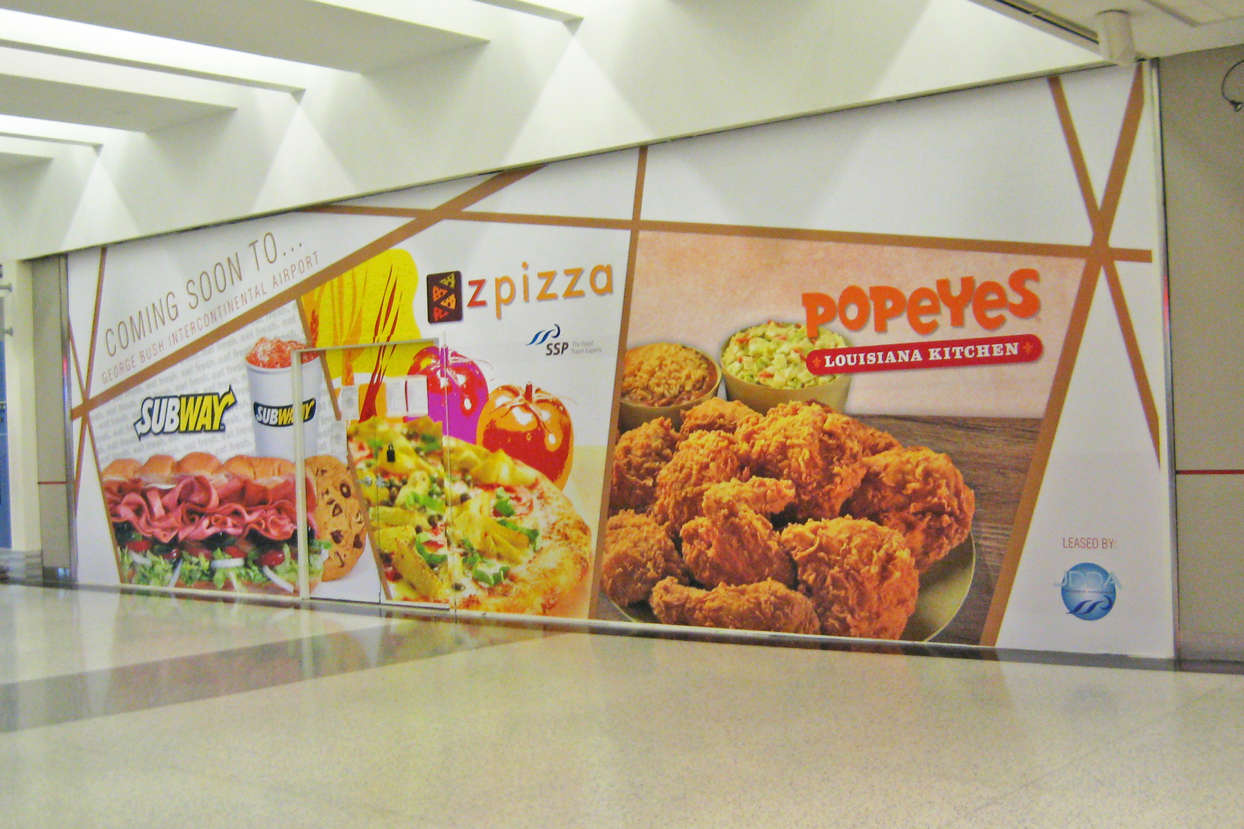 Popular Fast Food Chains using Barricade Wall Decals for Pre-Construction Advertising - Custom Designed and Installed to Fit Construction Space