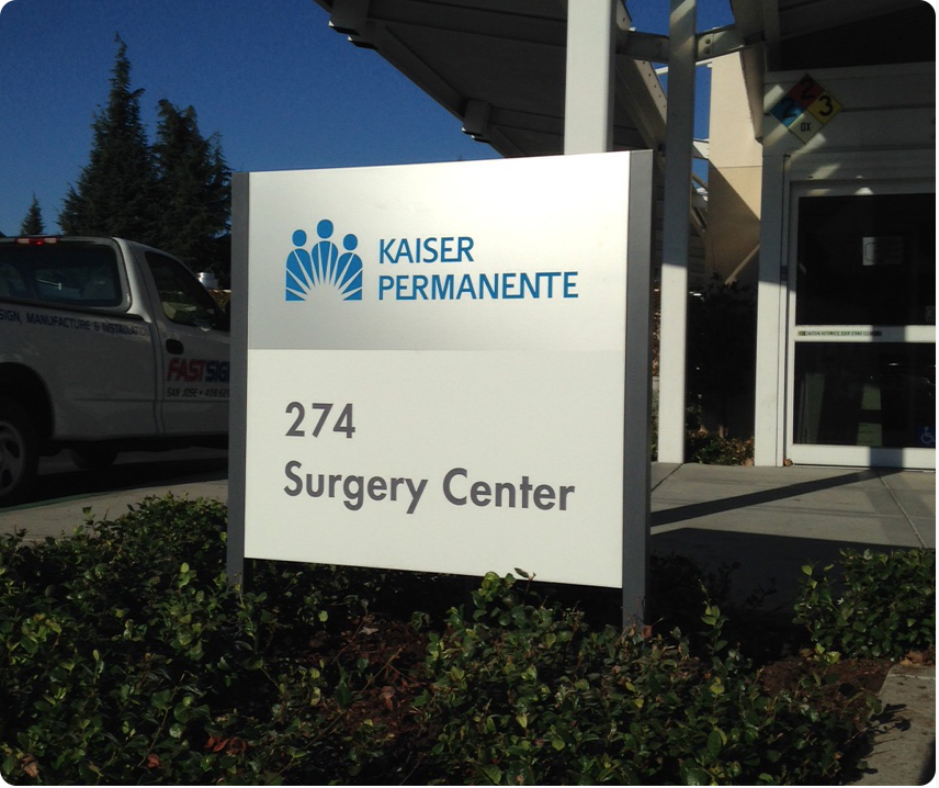 Small Wayfinding Tenant Sign for a Hospital Complex - 2 Panel Sign with Separate Panels for Tenant Name & Logo and Directional Information