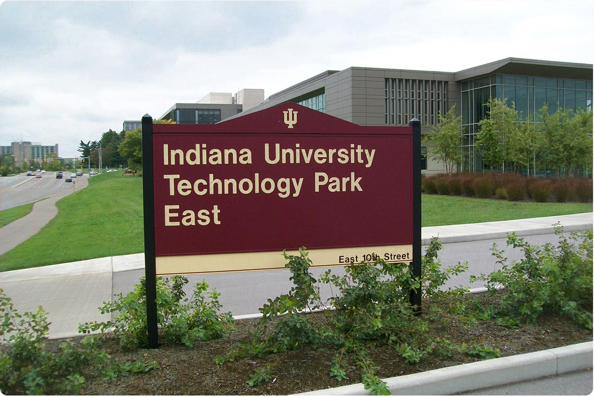 Business ID Sign for a University Park - 3" Thick Cabinet Style Frame Attaching Two Panels and Custom Triangular Header with No Visible Retainers or Exposed Fasteners for a Frameless Appearance