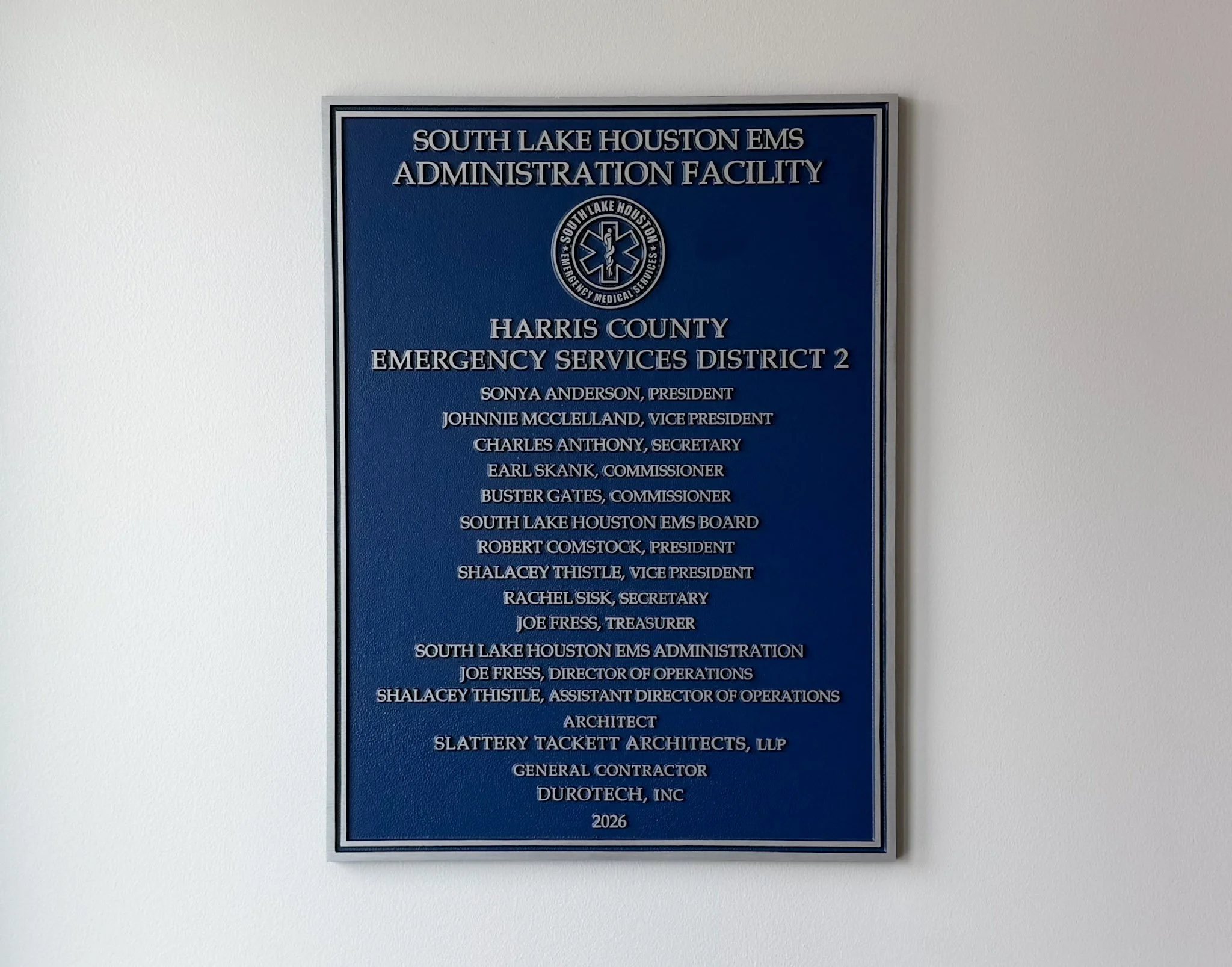 Custom dedication plaque for South Lake Houston EMS and Harris County Emergency Services District 2 mounted on an interior wall.