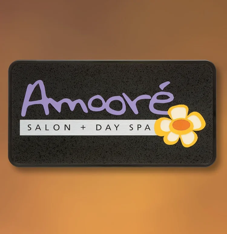 Framed ADA salon sign with tactile lettering and Braille for Amoré Salon + Day Spa, Houston.
