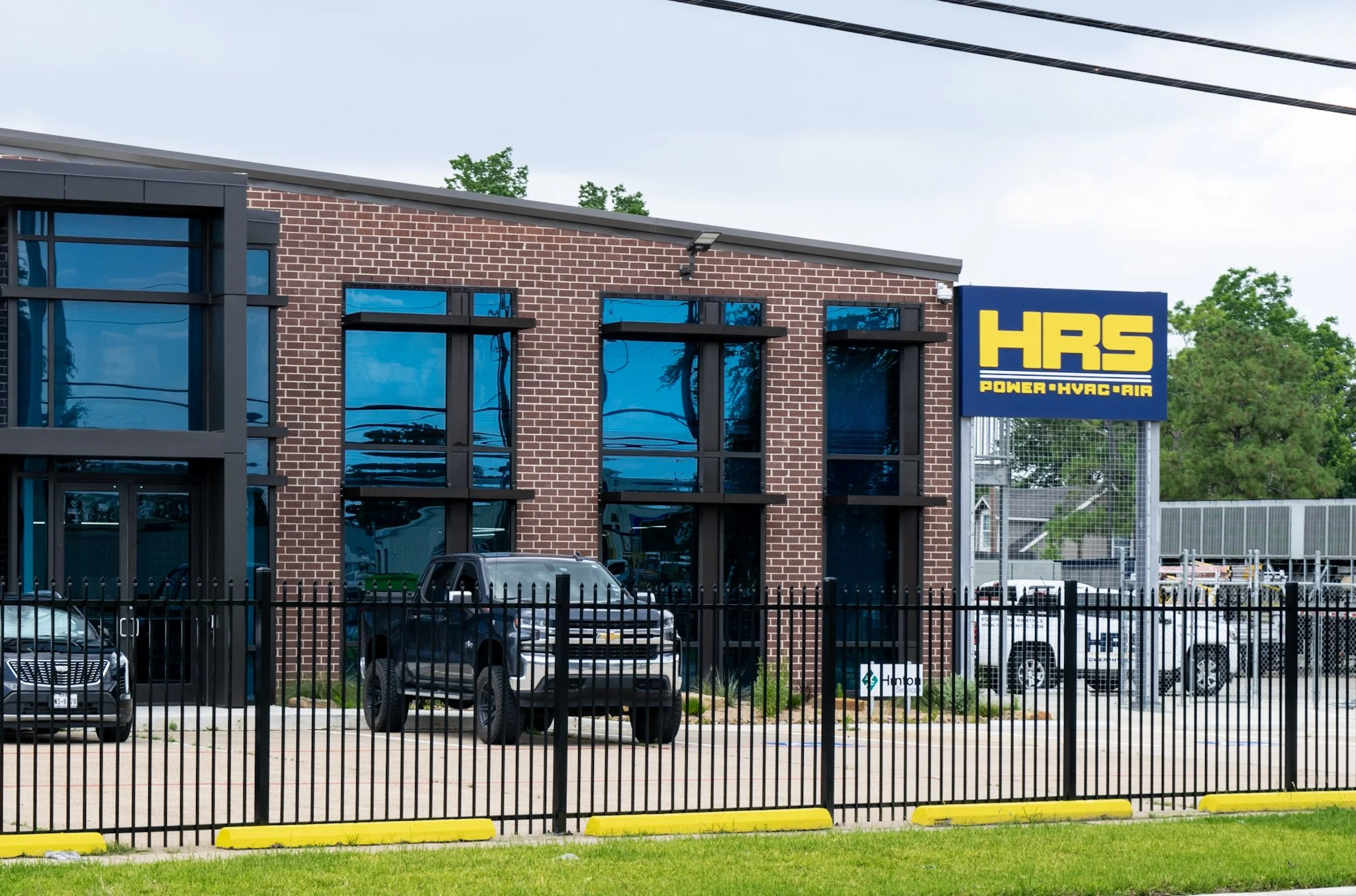 Freestanding pole sign for HRS Power HVAC Air installed outside a commercial office building in Houston, Texas.