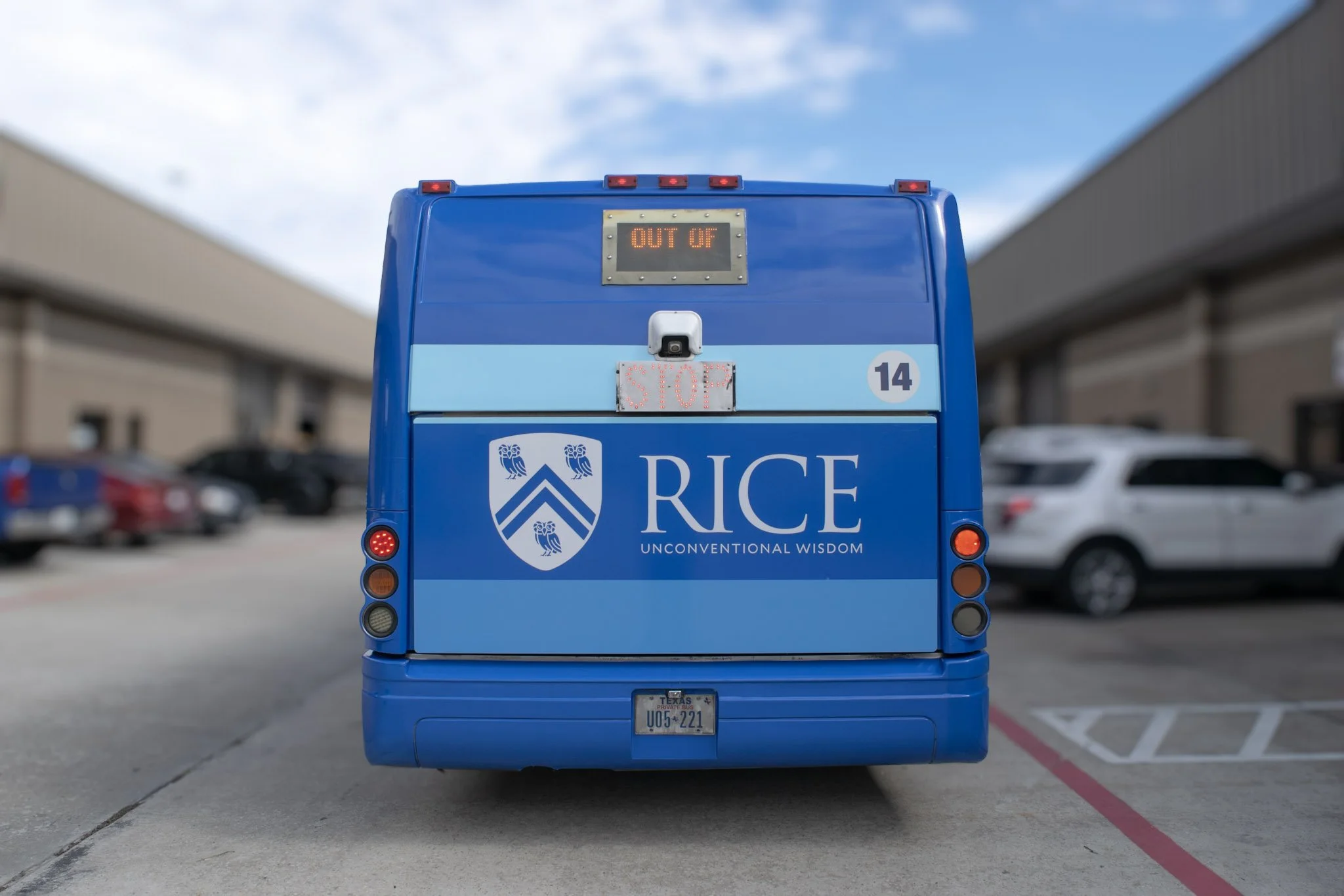 Rear view of a custom Rice University shuttle bus wrap installed by Saifee Signs with university branding and full-color fleet graphics.