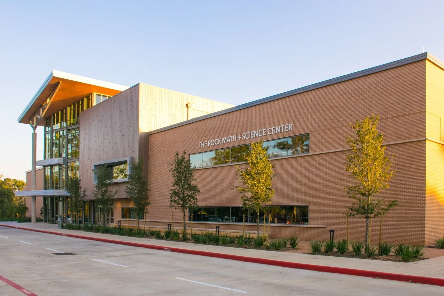 Houston school exterior signage at The John Cooper School science center building with modern brick architecture and clean institutional design.