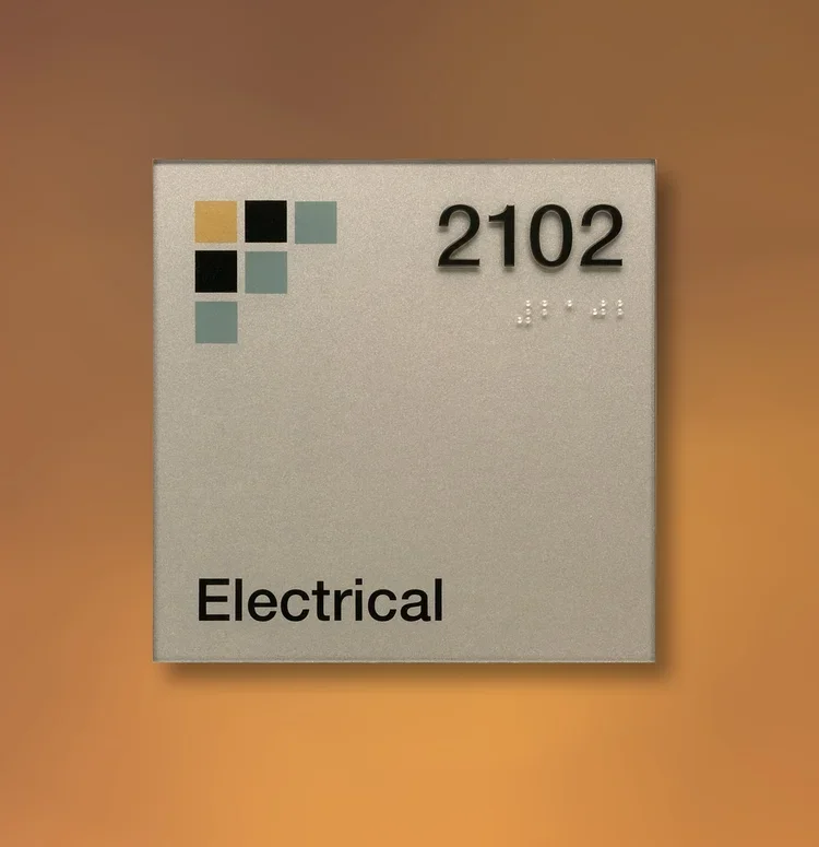 Standard ADA electrical room sign labeled 2102 with raised text and Braille, designed for building compliance in Houston.