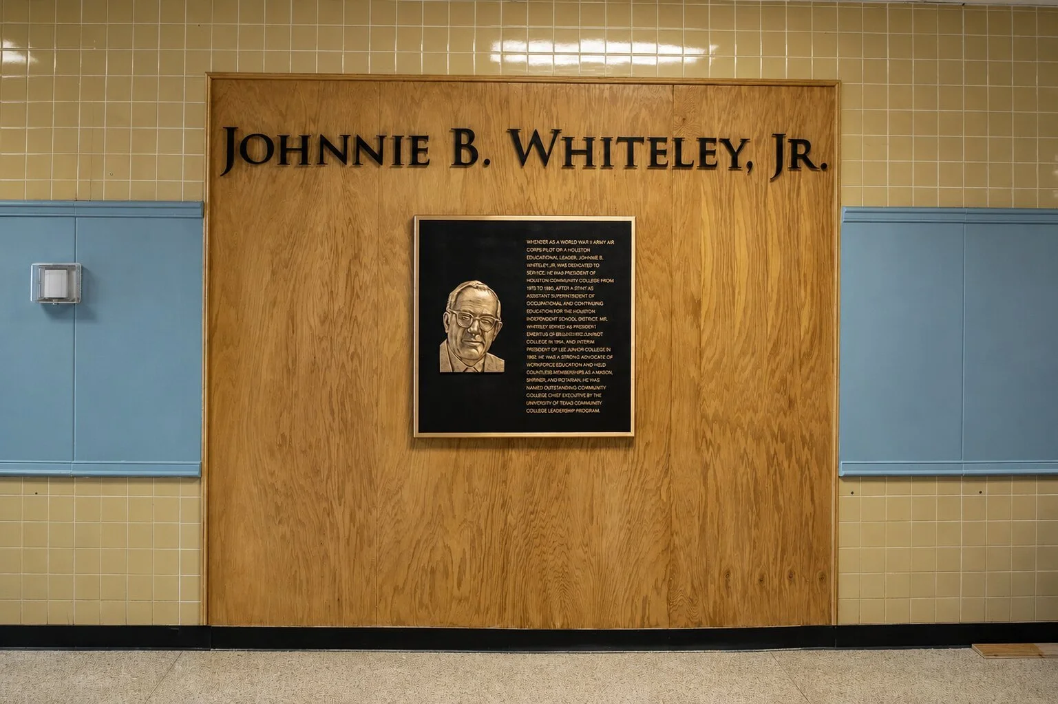 Bronze recognition plaque with portrait beneath dimensional lettering honoring Johnnie B. Whiteley Jr. at Houston Community College.