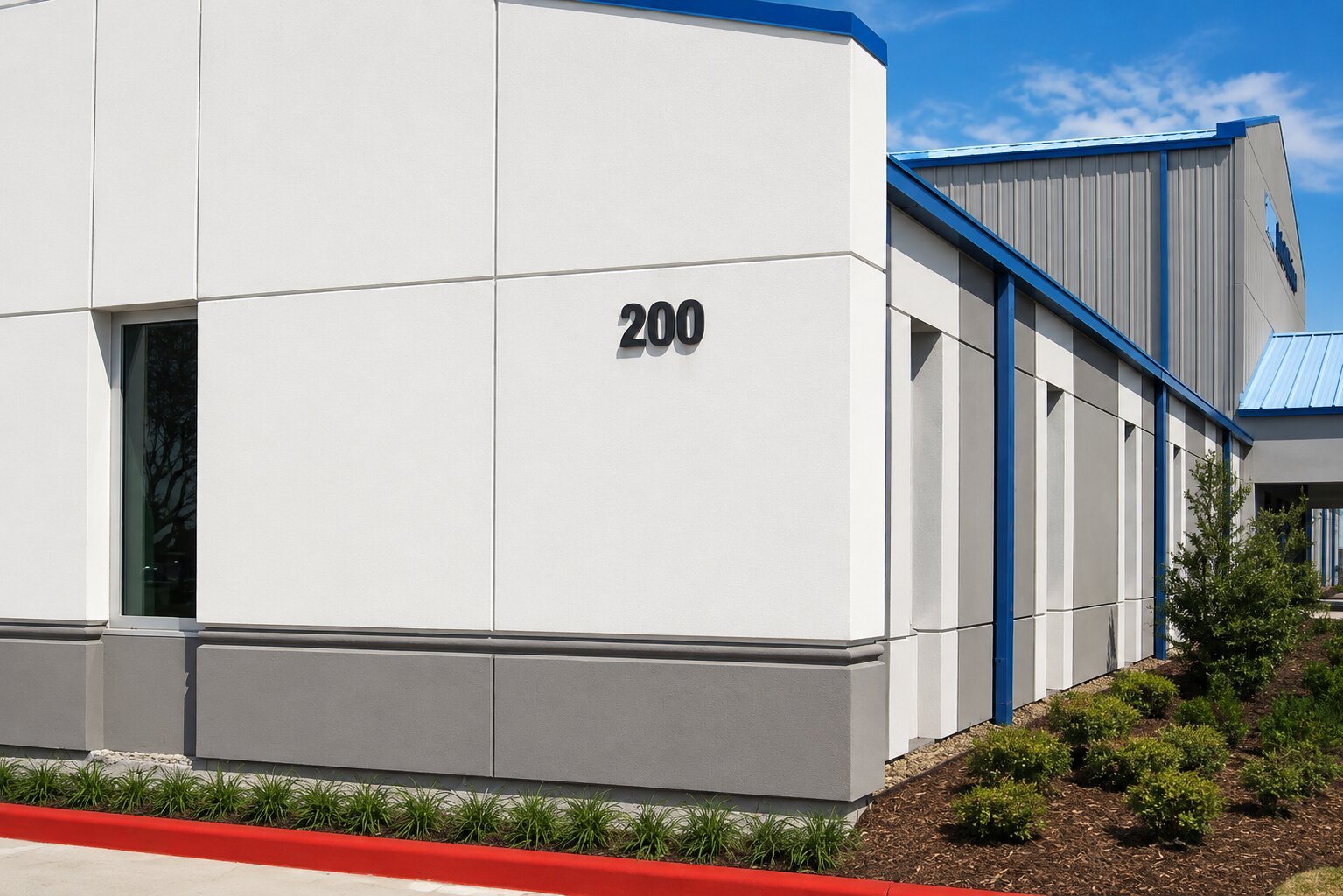 Black dimensional building address numbers mounted on the exterior facade of a modern commercial building for clear wayfinding and identification.