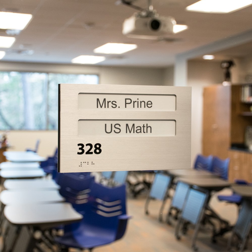 Brushed metal ADA classroom signage for Mrs. Prine US Math 328 at The John Cooper School in The Woodlands, Texas.