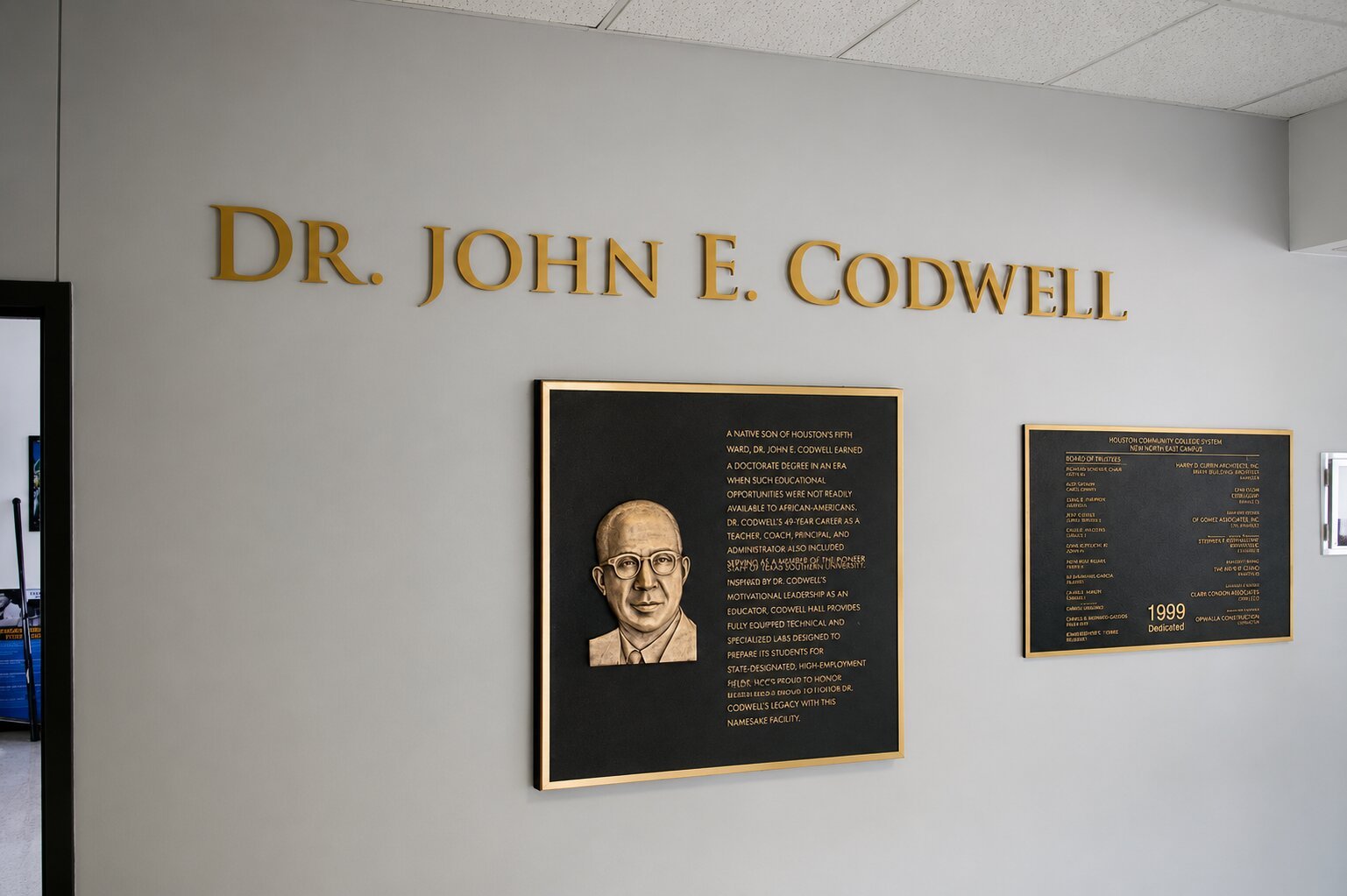 Bronze recognition plaque featuring a portrait and dimensional lettering honoring Dr. John E. Codwell at Houston Community College.