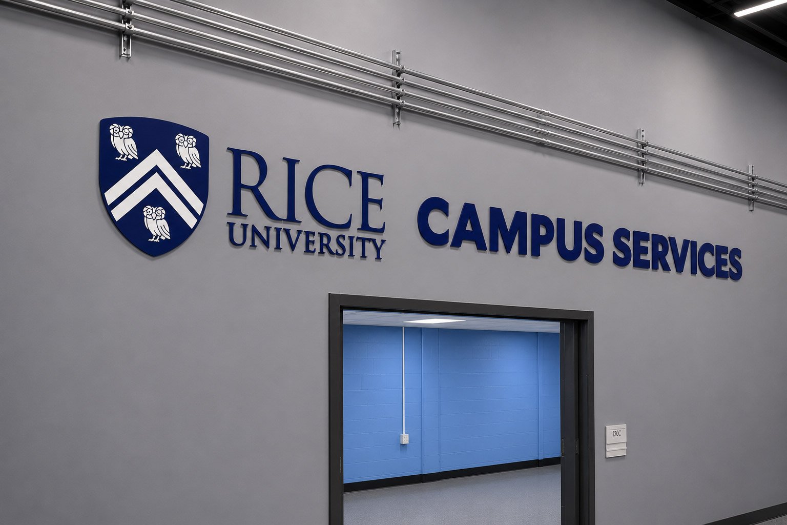 Interior dimensional logo and lettering for Rice University Campus Services installed above a hallway entrance.