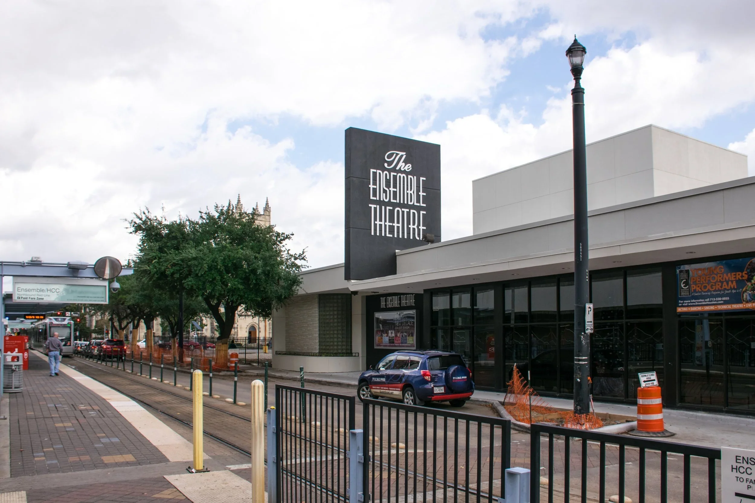Houston theatre signage at The Ensemble Theatre with bold vertical exterior sign and urban streetscape branding visibility.