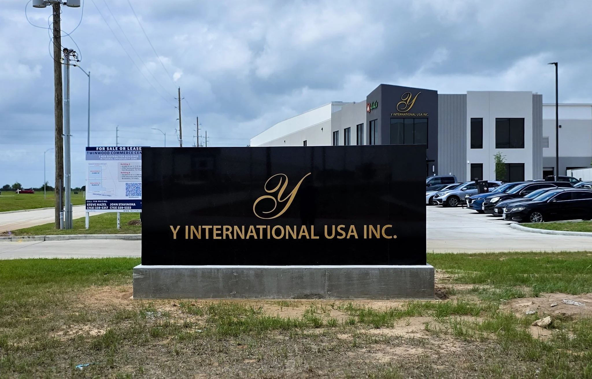 Modern monument sign with dimensional lettering installed at the Y International USA Inc. corporate facility entrance for business identification.