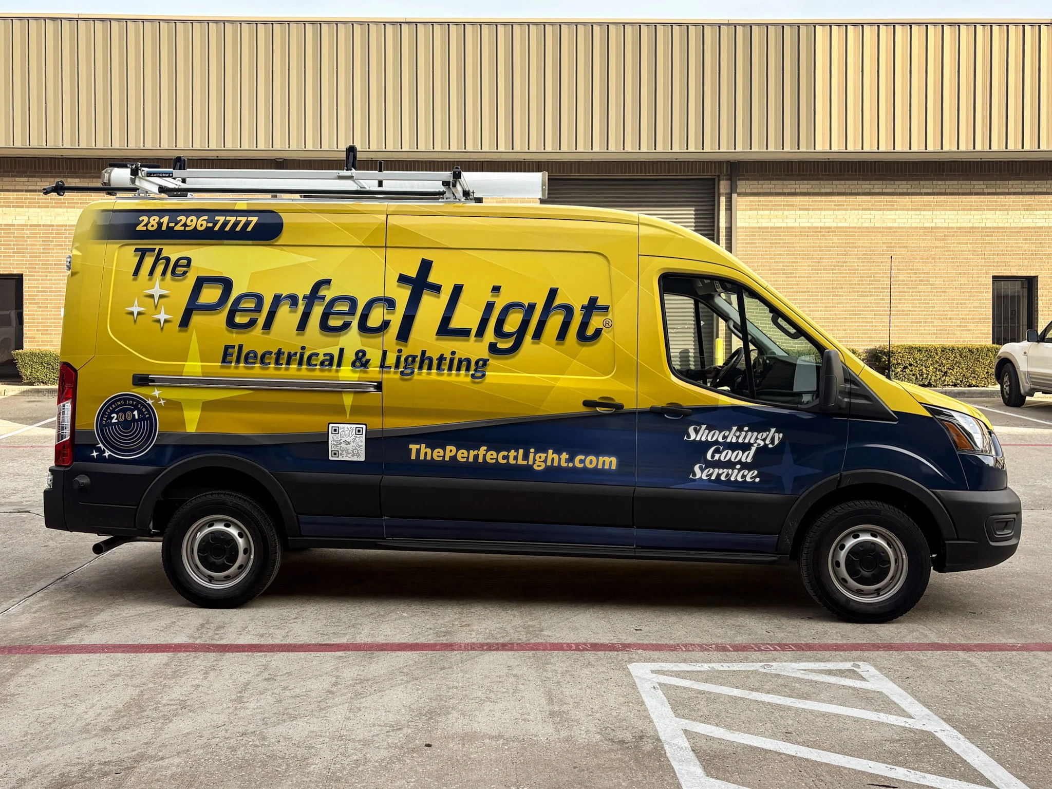 Commercial van wrap for The Perfect Light Electrical & Lighting featuring bright yellow and navy graphics, branding, website, and QR code.