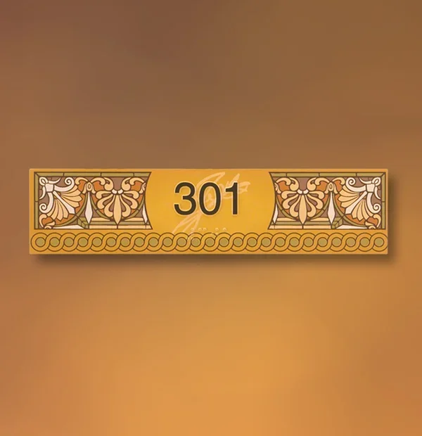 Decorative ADA room number sign in Houston displaying “301” with raised tactile numerals on a gold background and an elegant floral border.