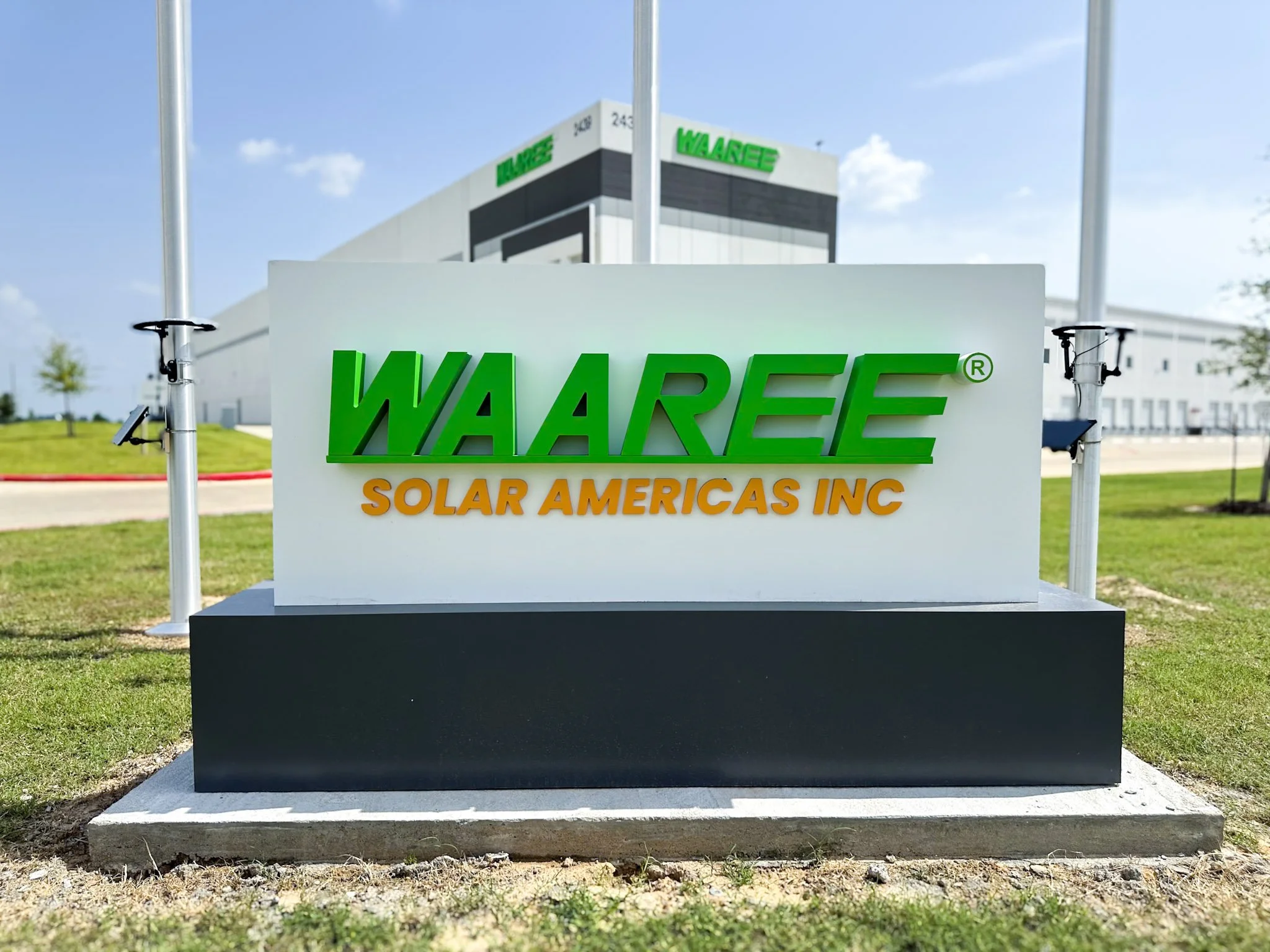 Custom monument sign with dimensional lettering installed at Waaree headquarters entrance, featuring a modern masonry base and outdoor business signage.