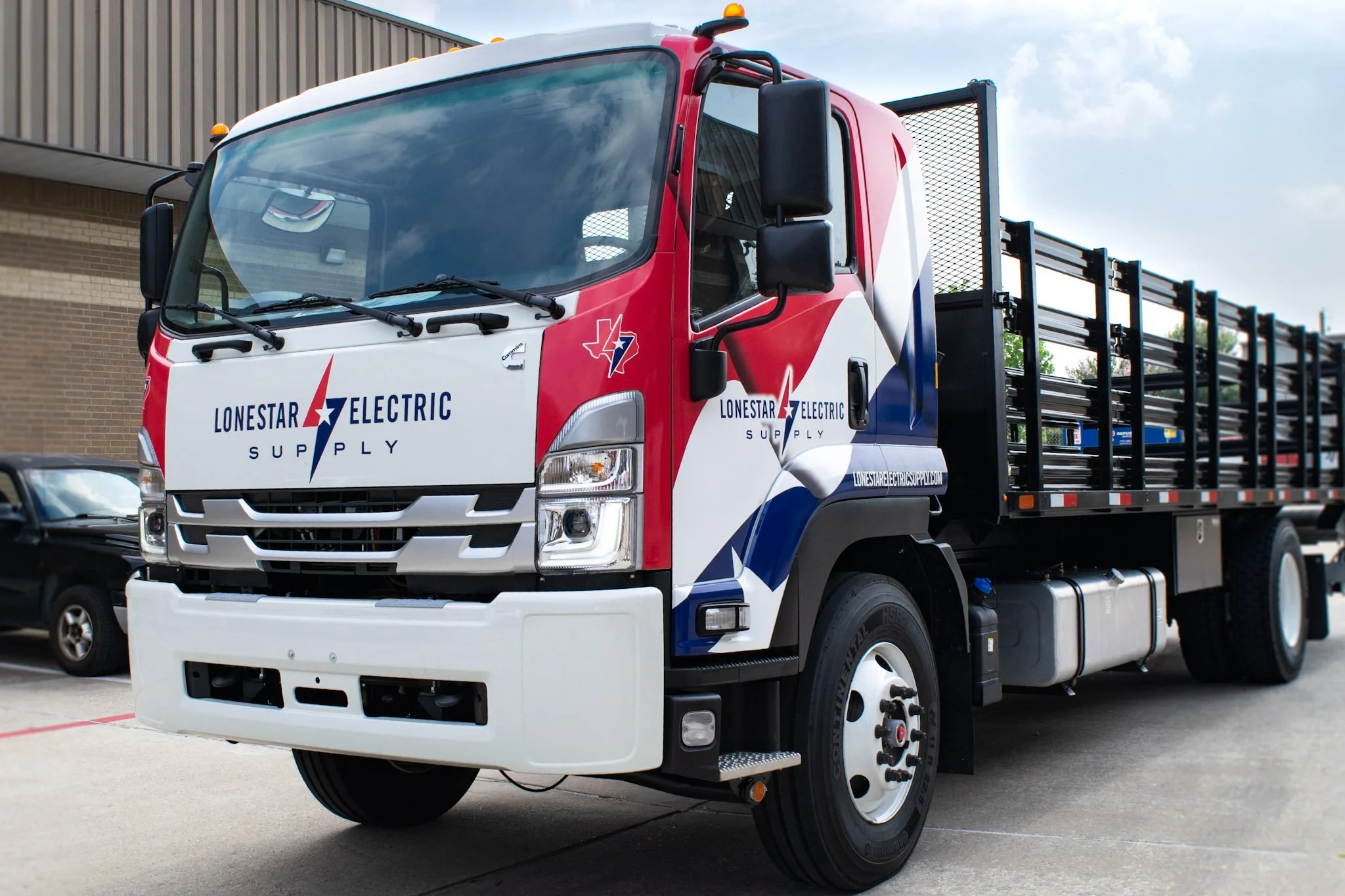 Commercial truck wrap for Lone Star Electric Supply featuring red, white, and blue branded graphics across the cab.