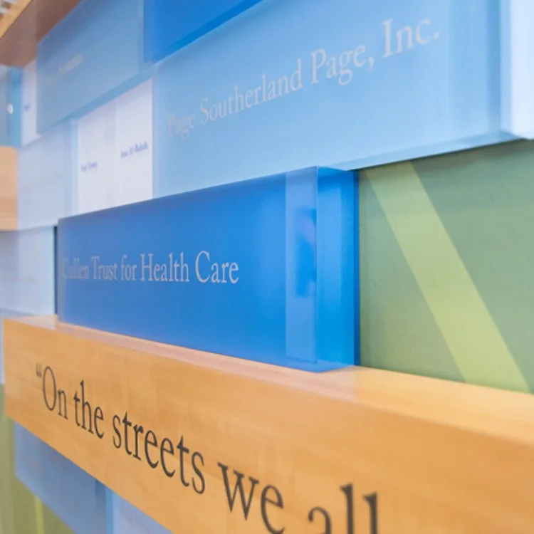 Interior donor recognition wall featuring layered acrylic panels and custom donor signage in a healthcare facility lobby.