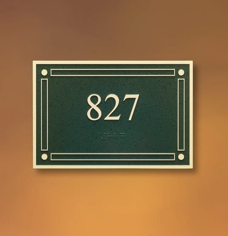 Framed ADA room number sign displaying 827 with raised characters and Braille, Houston.