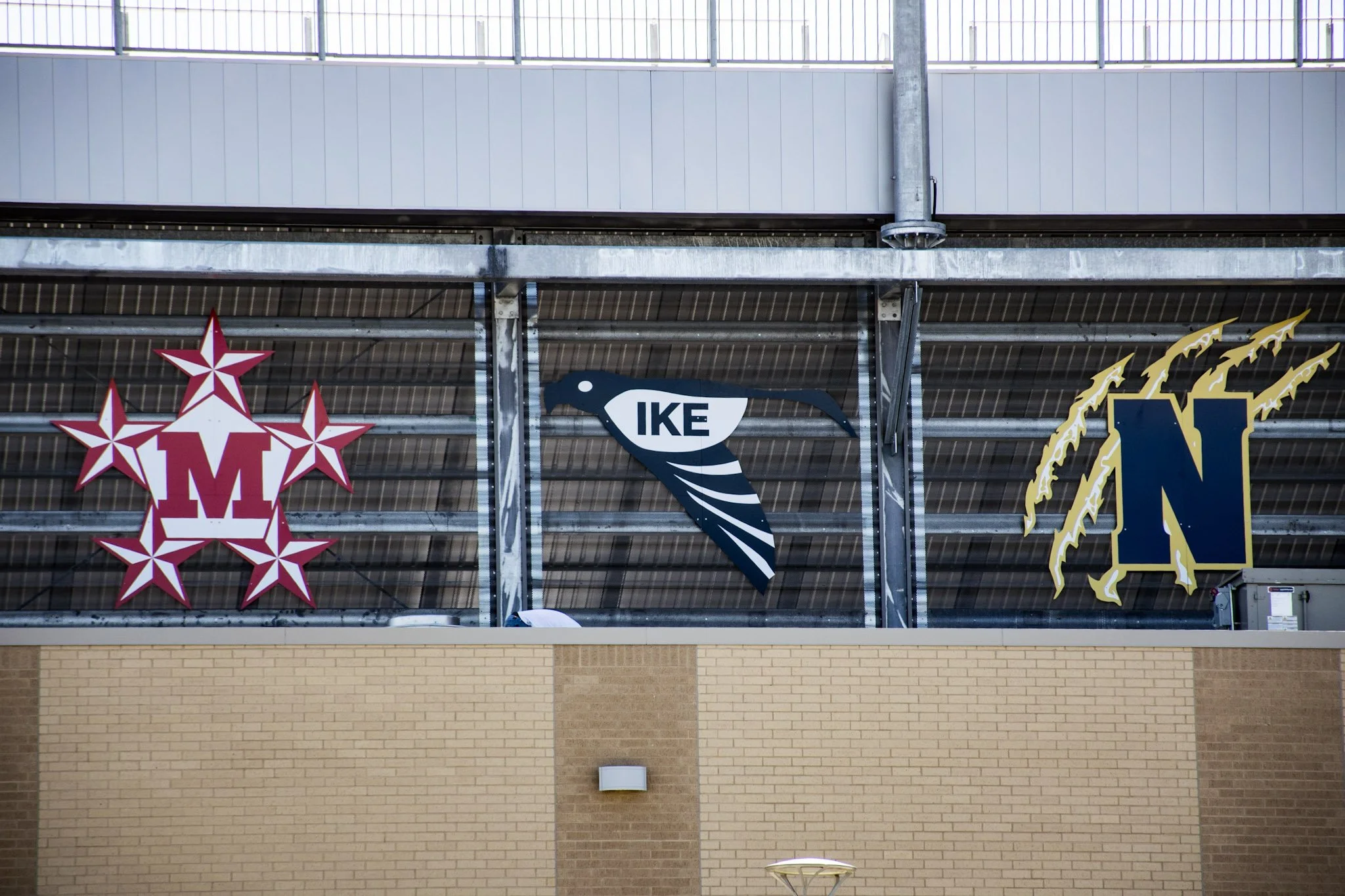 Digitally printed ACM school logo signage featuring MacArthur High School, Ike Middle School, and Nimitz High School at W.W. Thorne Stadium for Aldine ISD in Aldine, Texas.