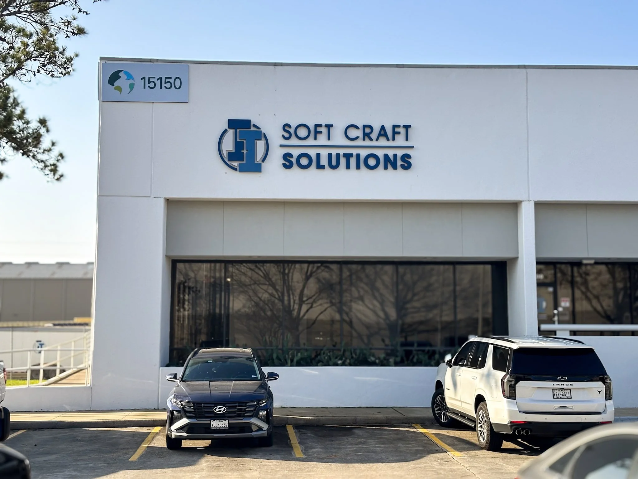 Blue dimensional logo and lettering installed as an exterior building sign for Soft Craft Solutions in Houston, Texas.