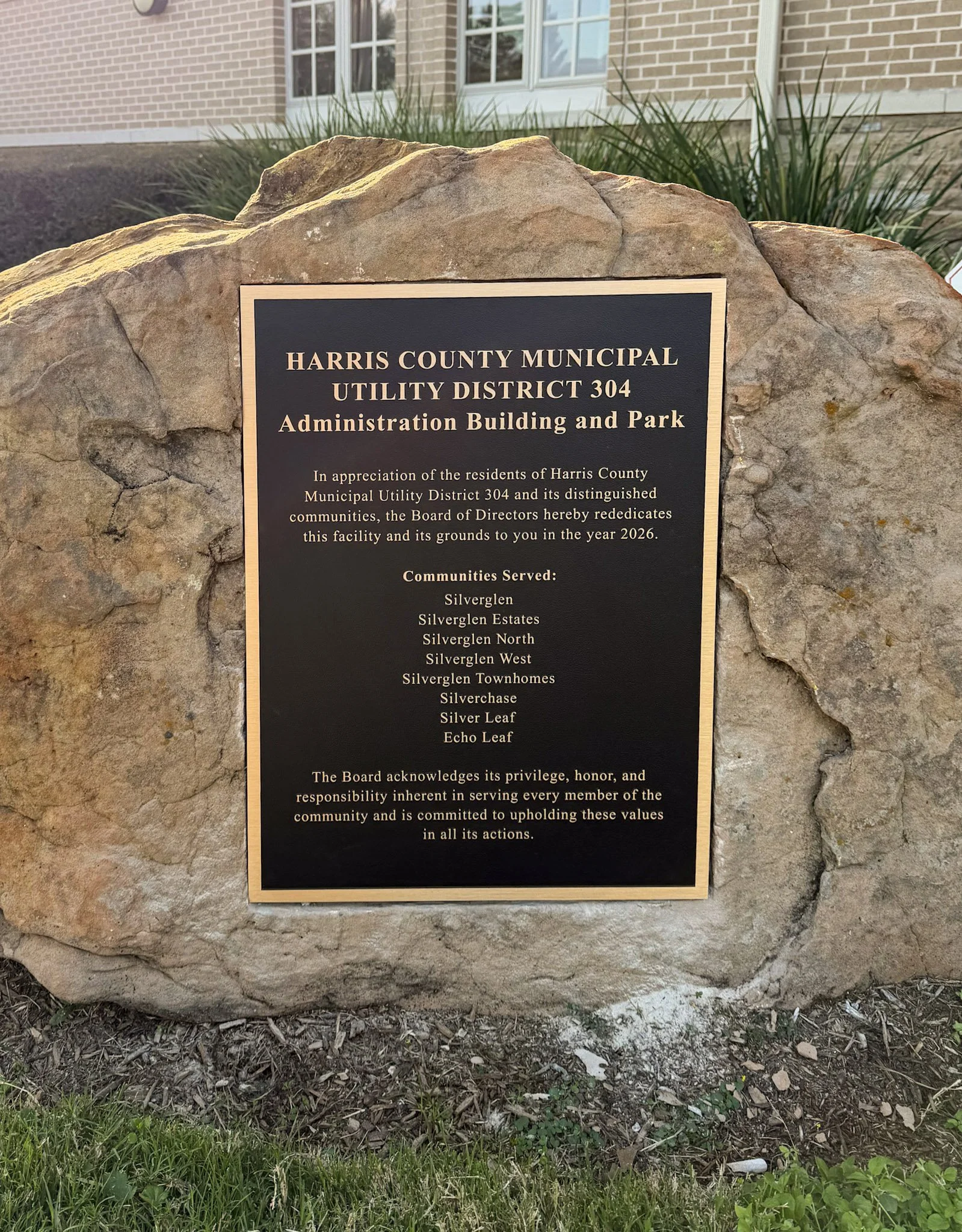 Custom dedication plaque for Harris County Municipal Utility District 304 Administration Building and Park mounted on a large stone.