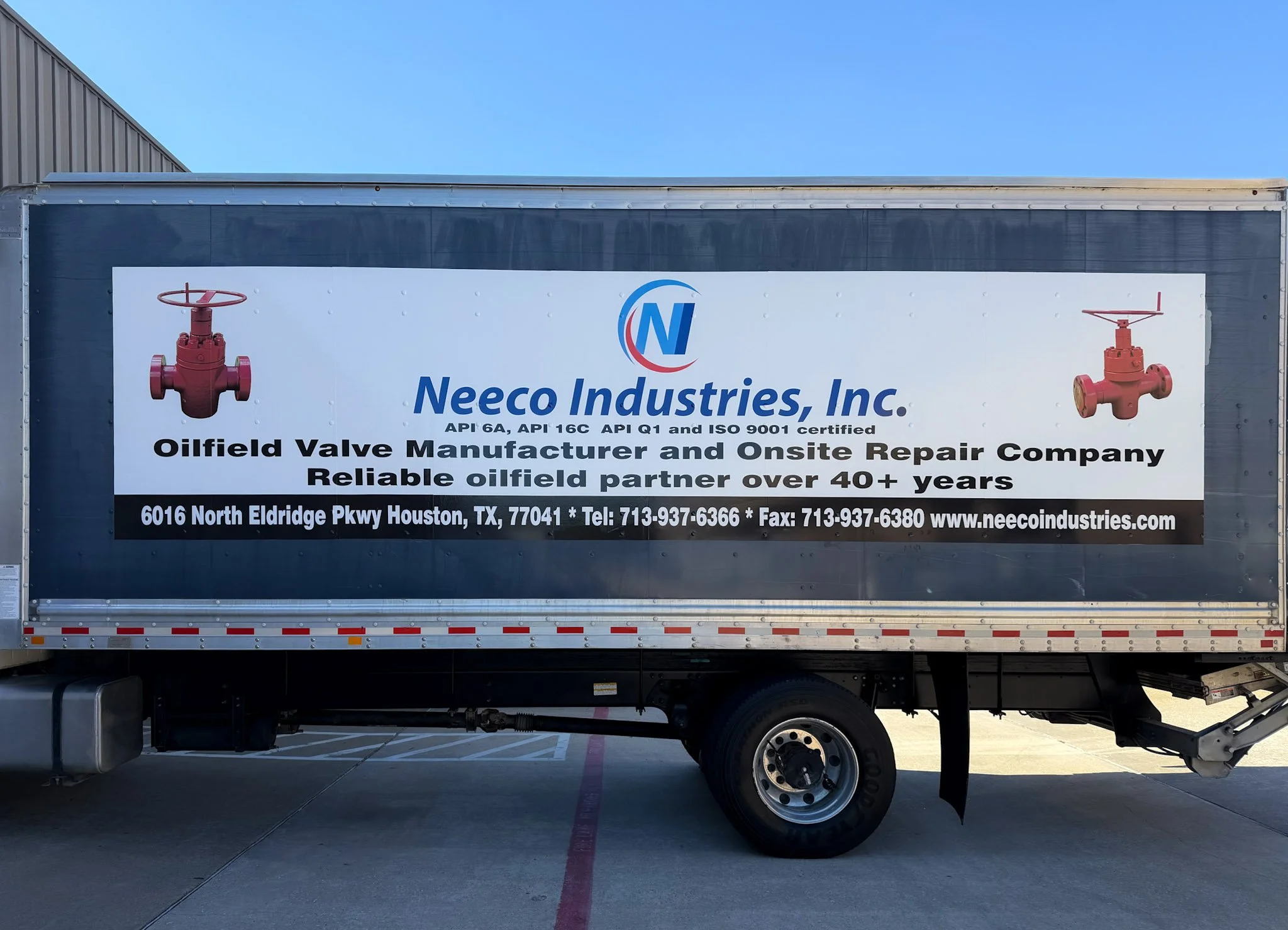 Neeco Industries box truck wrap with oilfield valve graphics, company contact details, and Houston address on industrial truck.