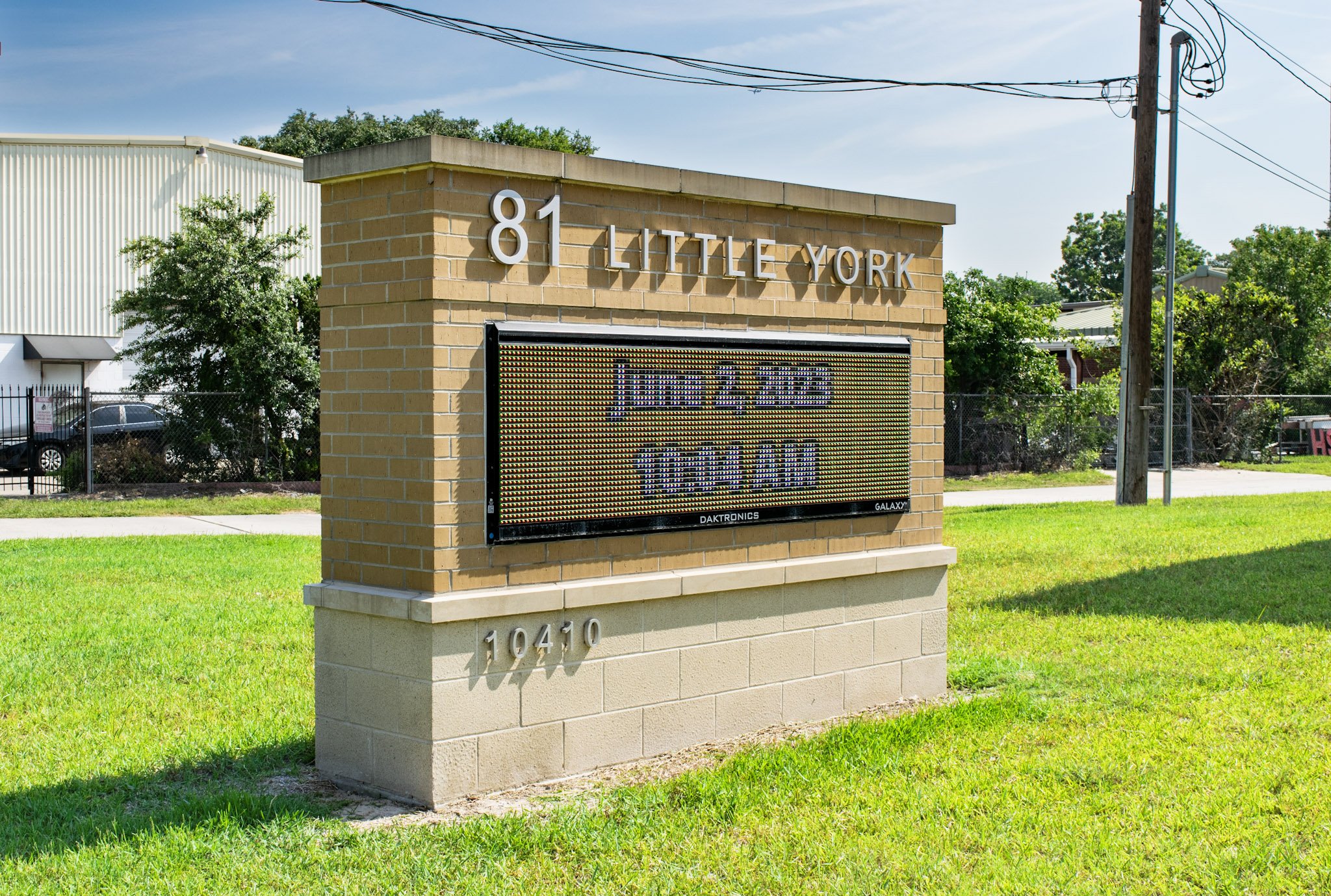 Brick monument sign with a digital message display installed at the Little York Fire Station for facility identification and public messaging.