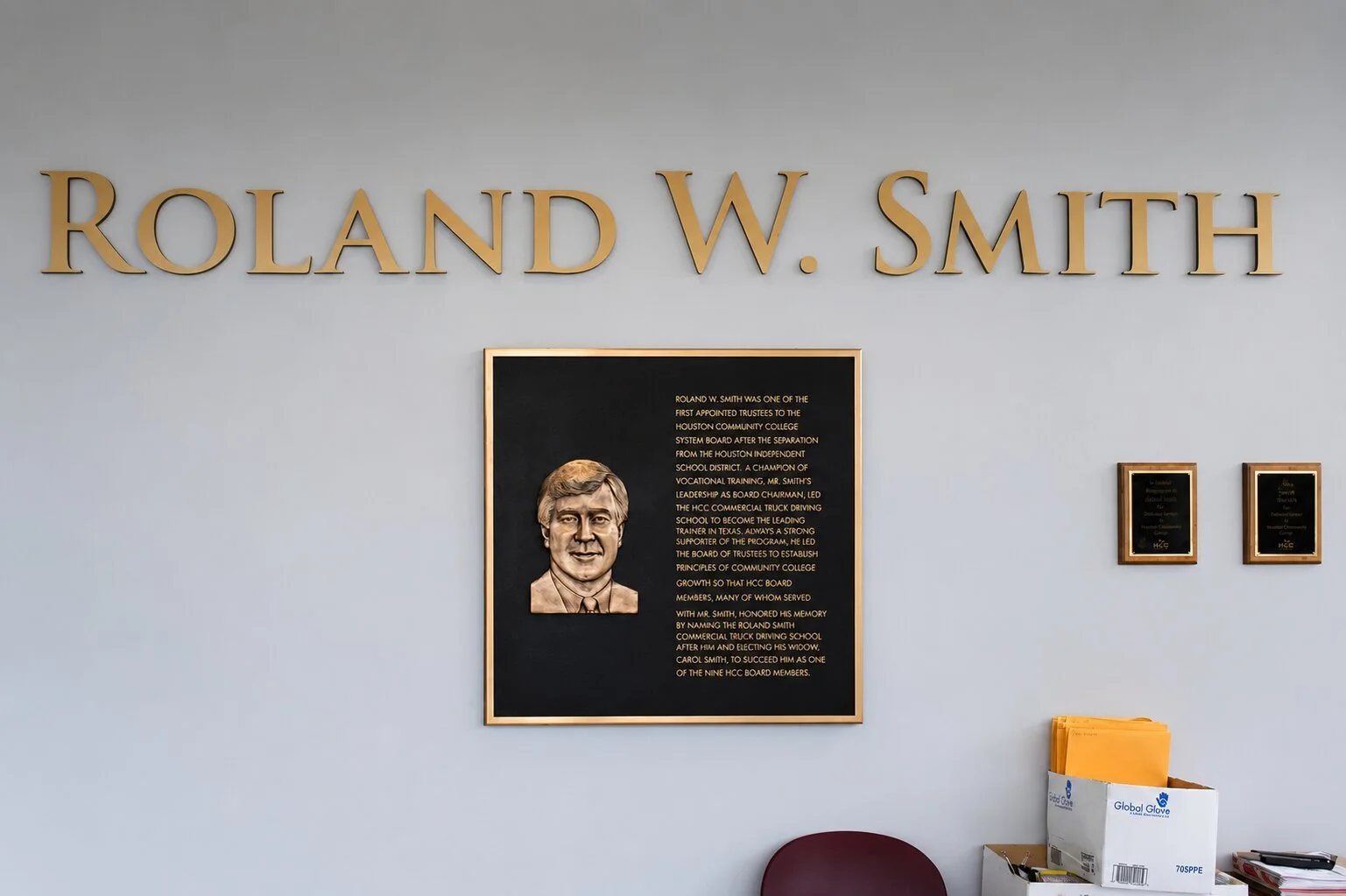 Bronze recognition plaque with portrait and large dimensional lettering honoring Roland W. Smith at Houston Community College.