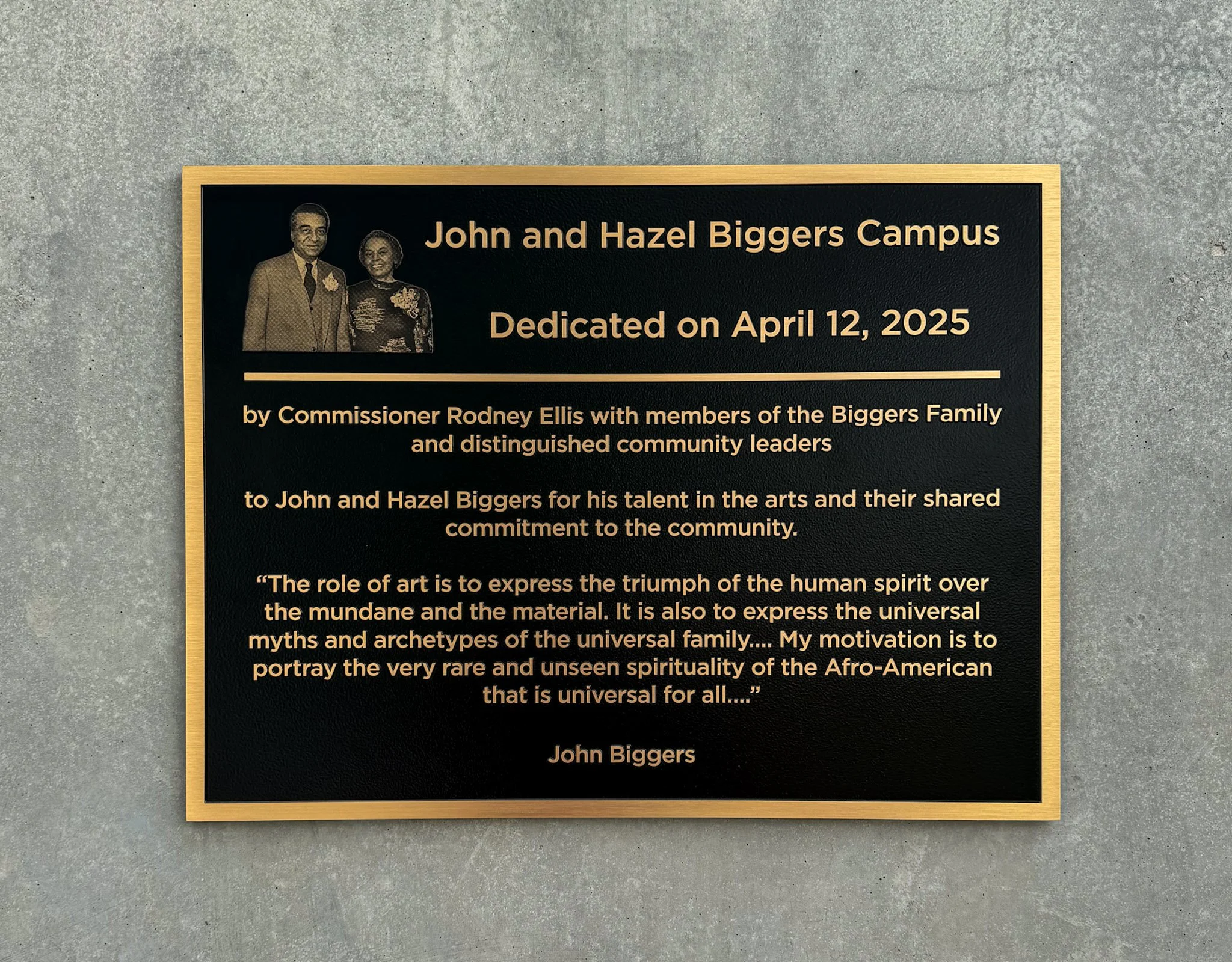 Custom dedication plaque for the John and Hazel Biggers Campus featuring a photo and raised lettering on a black metal background.