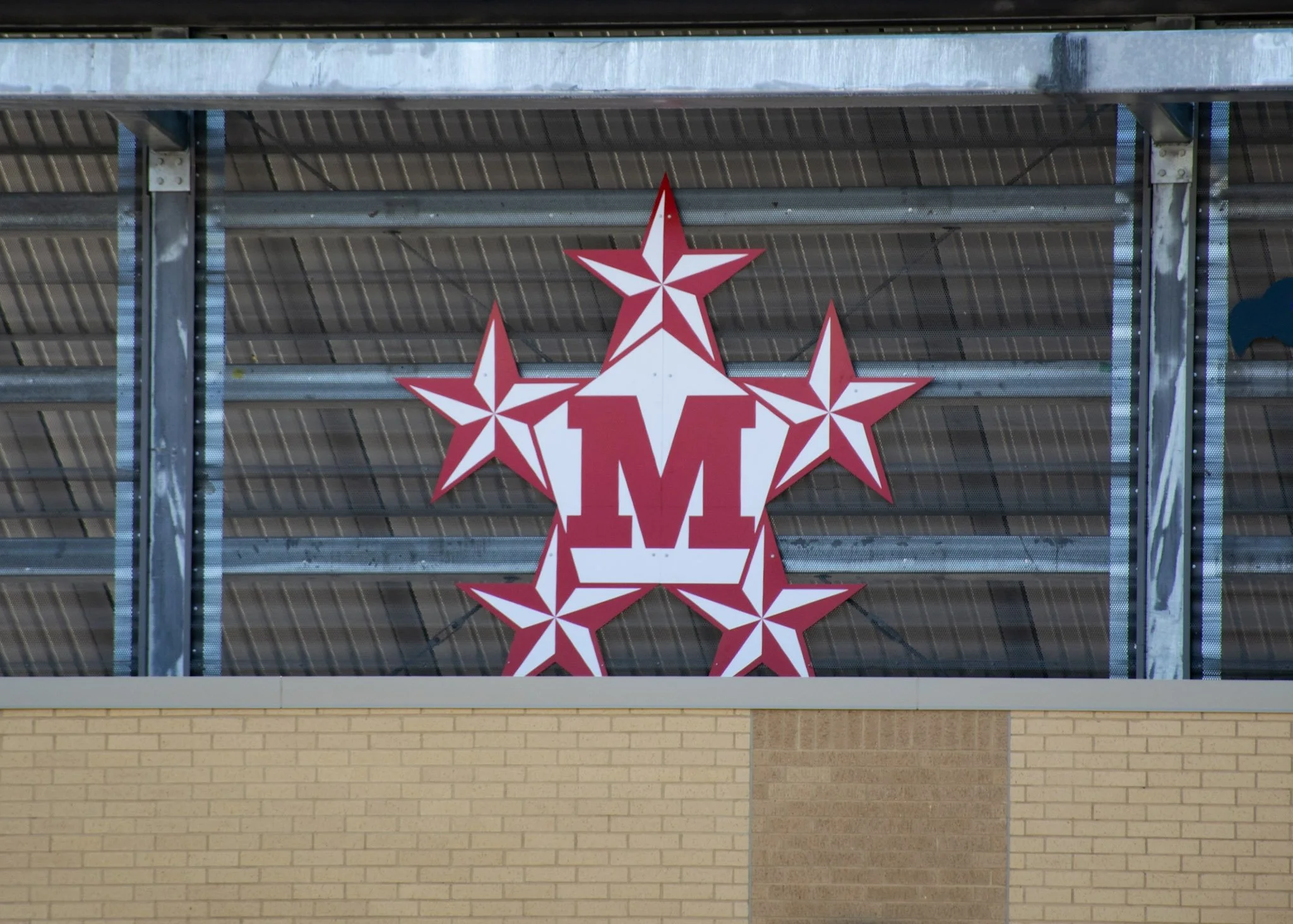 Digitally printed ACM MacArthur High School logo signage installed at W.W. Thorne Stadium for Aldine ISD in Aldine, Texas.