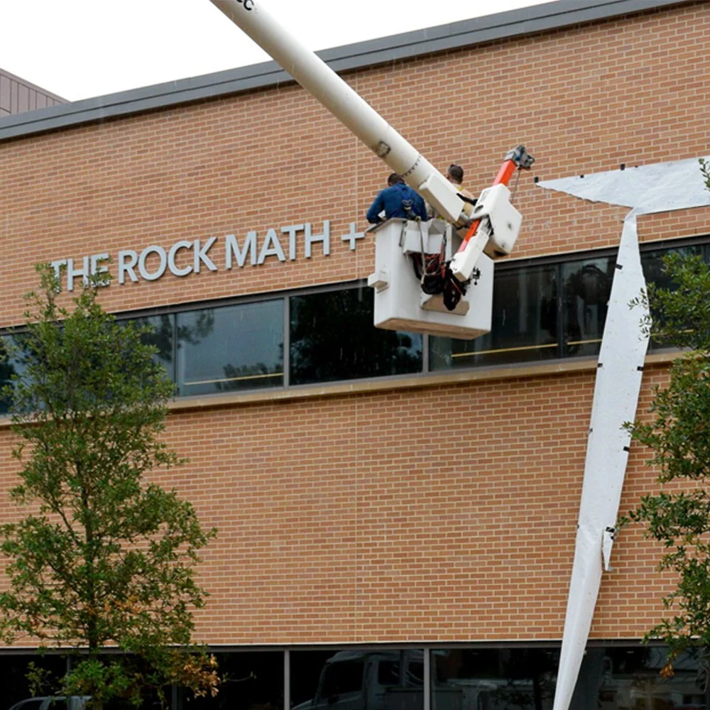 Professional installation of exterior dimensional letter signage for THE ROCK MATH + SCIENCE CENTER at The John Cooper School.