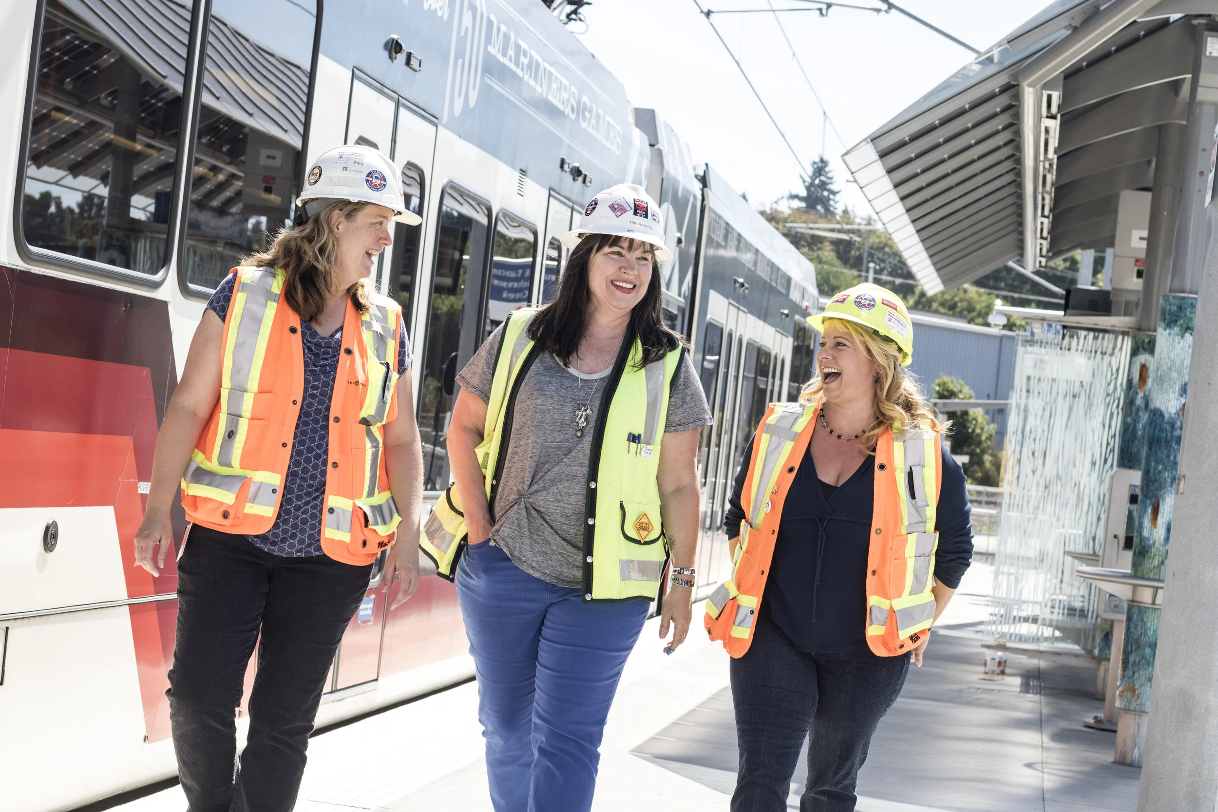 Engineers Leah Robbins, Teresa Boyle, and Stacy Bluhm tour the new Tacoma Street Max Stop on the TriMet Orange Line.