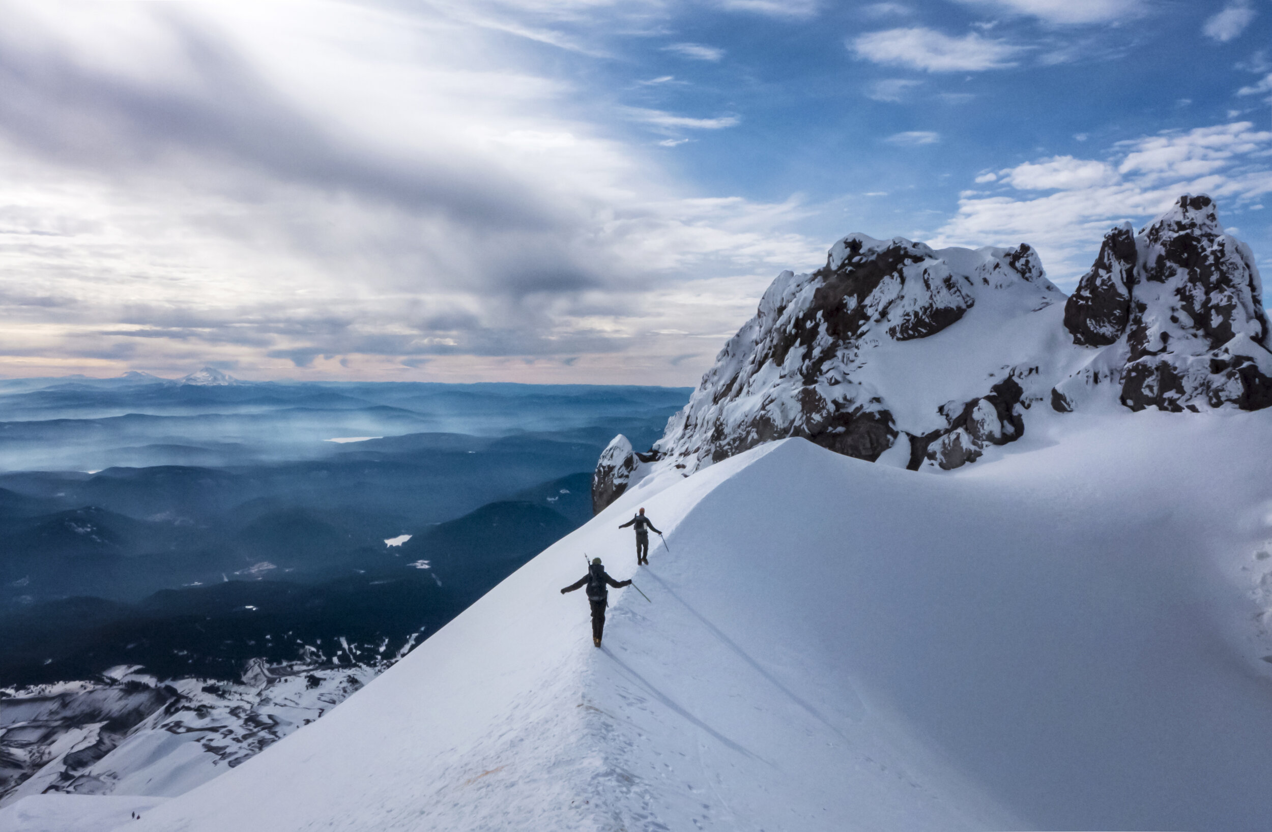 Climbers on the upper reaches of Mount Hood walk along the Hogsback during a favorable November weather window.