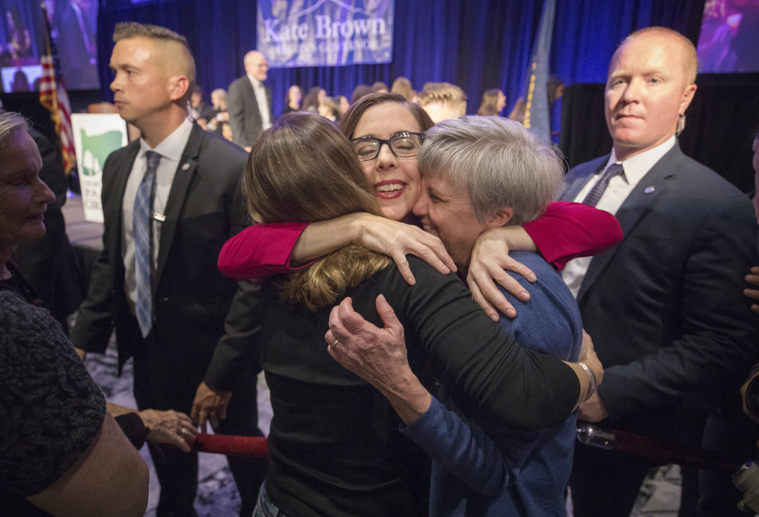 Oregon governor Kate Brown hugs supporters after giving a victory speech during election night.