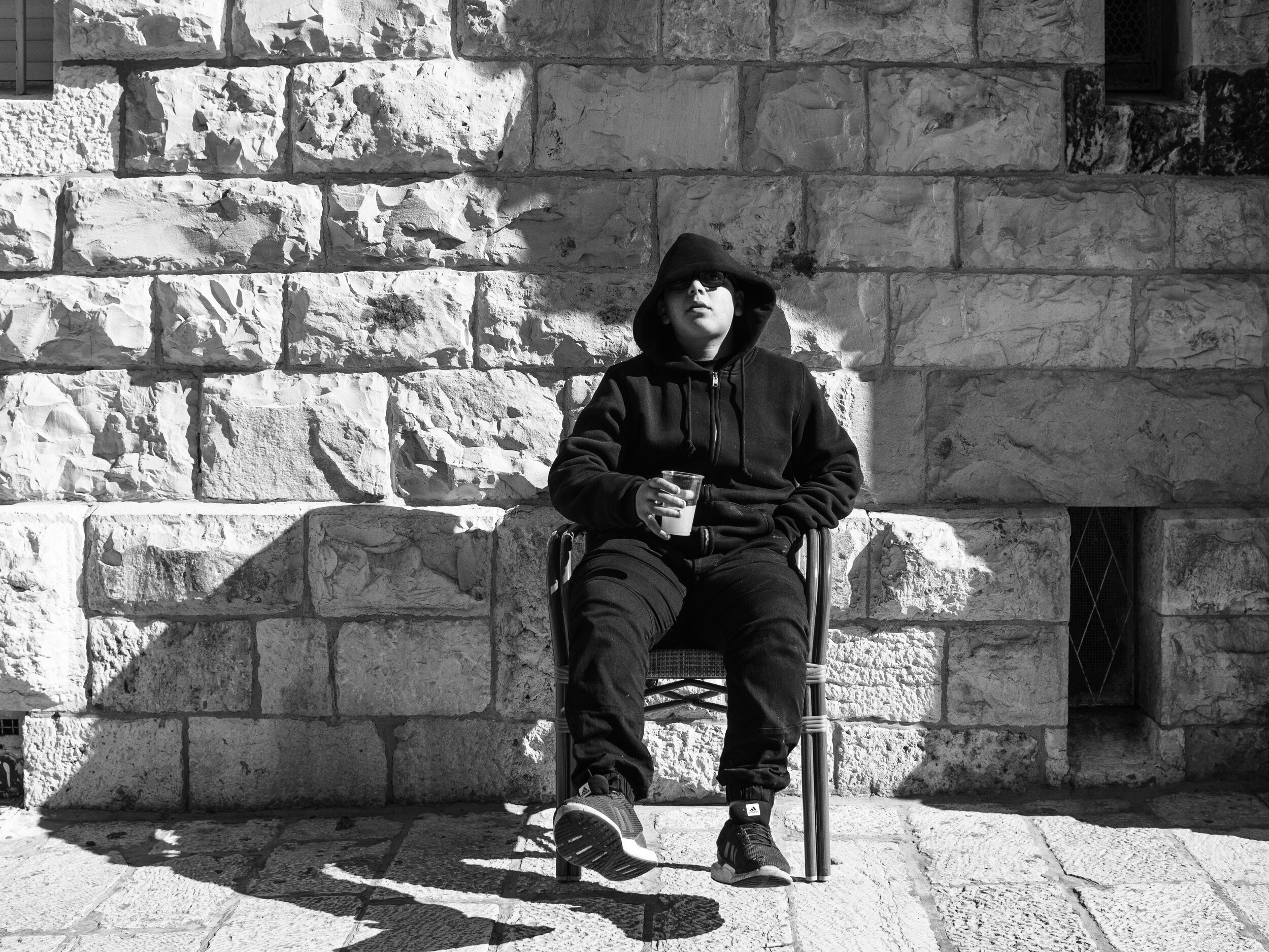  Leaned back against the church. He had this sort of street vibe that went outside a coffee shop’s commerce. I wasn’t sure if he was working the cafe or the block. 