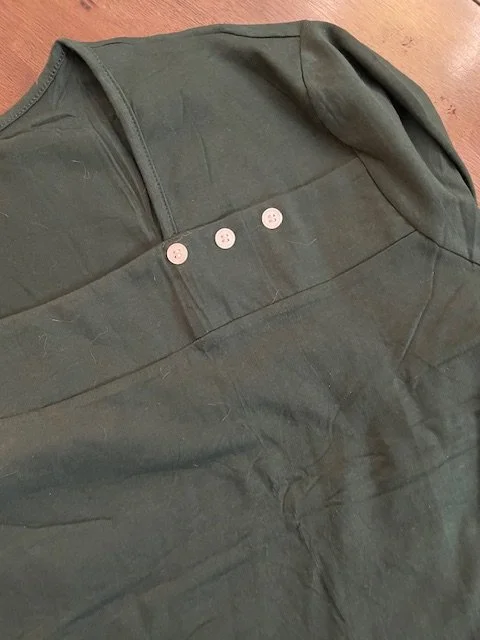 long sleeve green shirt with asymmetrical neckline