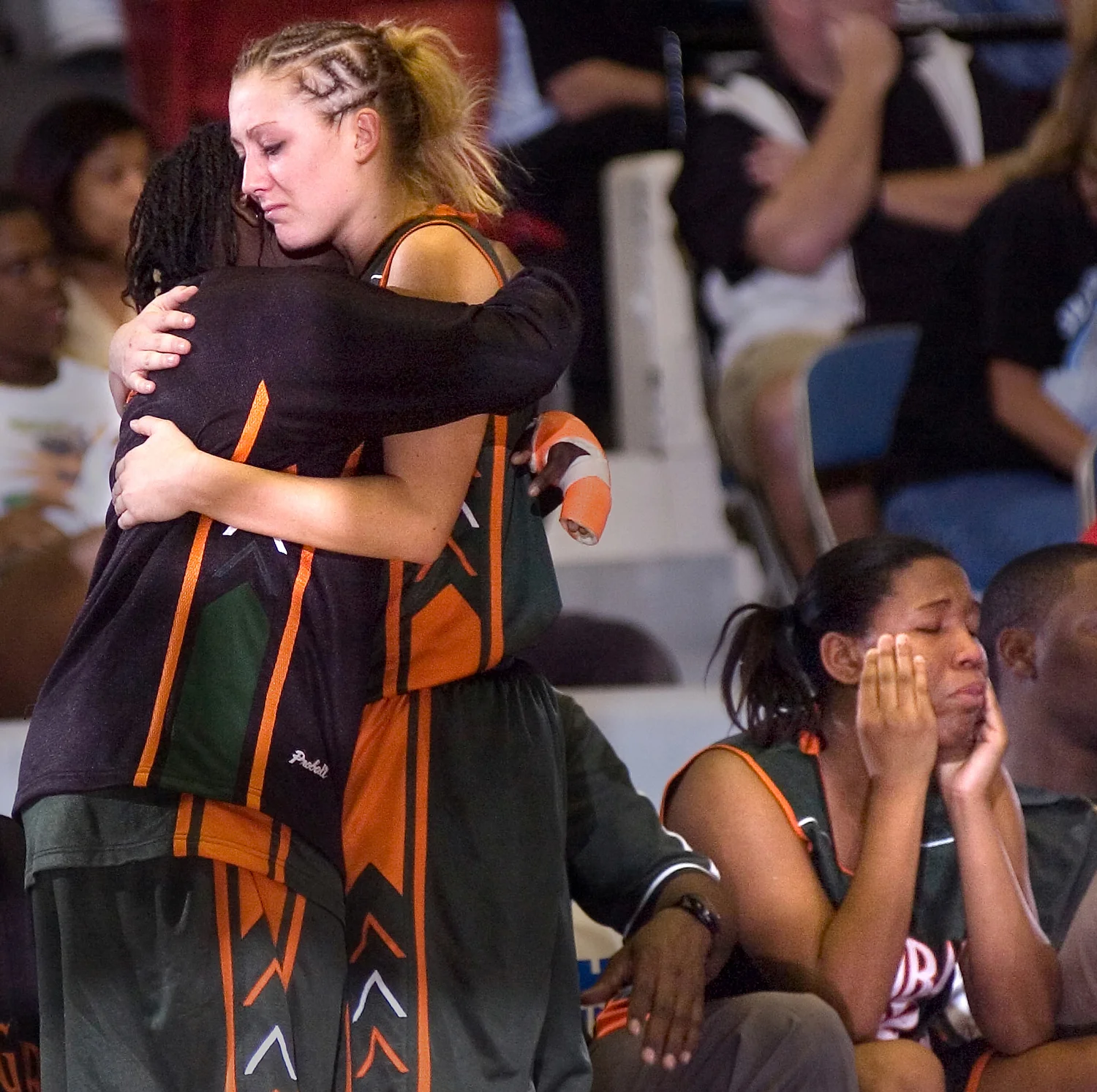  Dunbar High School's Lashonda Thomas, left, and Kylie Dickey, console each other after losing to Jensen Beach in the FHSAA Class 4A Girls Basketball Finals. Teammate Brittany Brown is at right.&nbsp; 