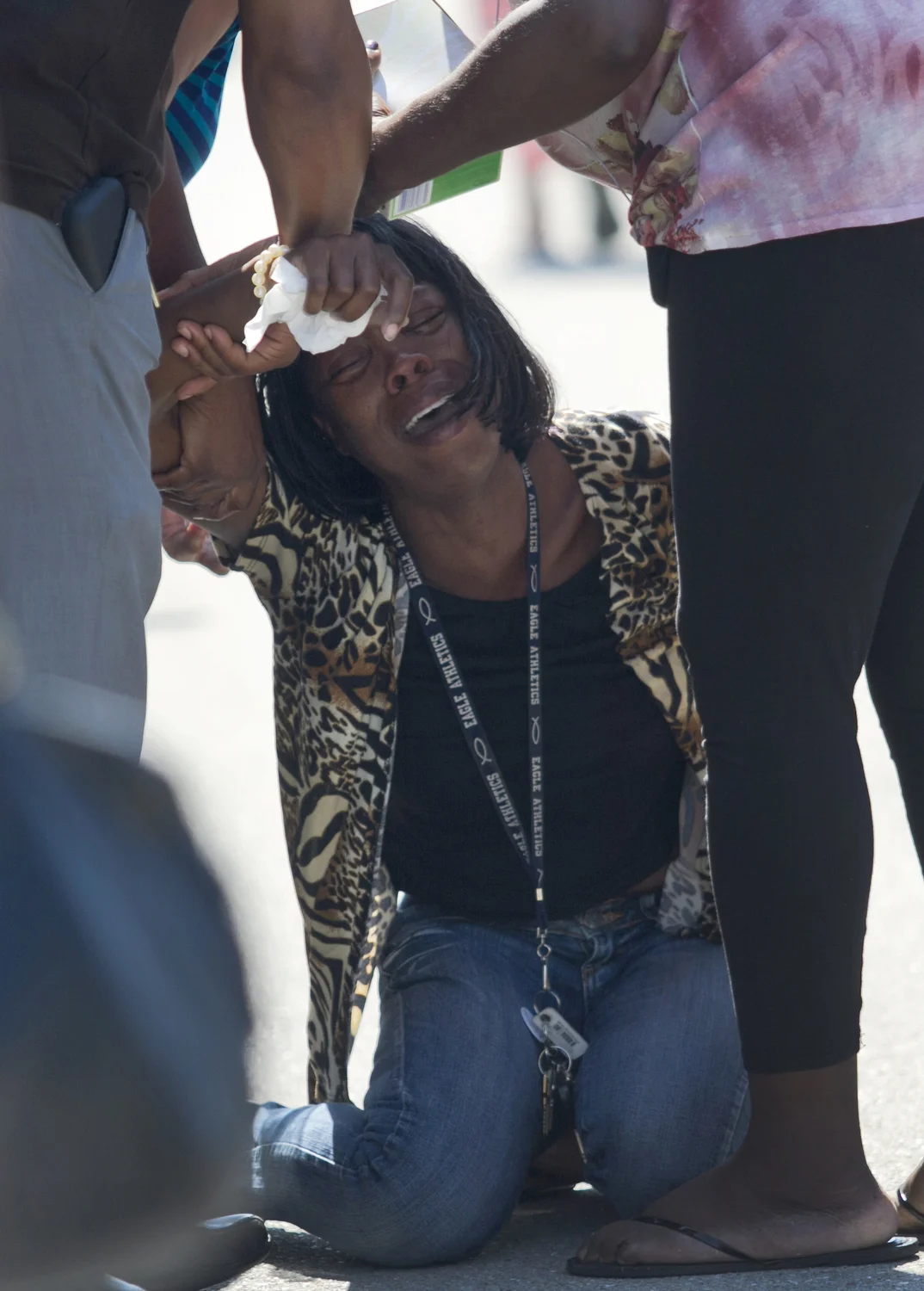  The wife of a double murder victim is comforted as she grieves on the scene. The victims, who were brothers, were found shot in a car early Saturday. Both died from gunshot wounds. 