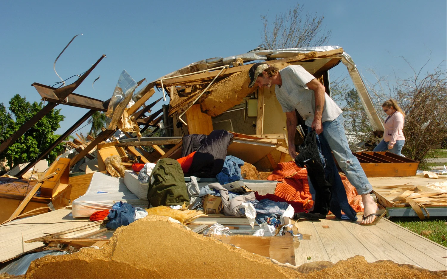  Bill Barton, 47, of Clewiston removes some of his clothing from his mobile home with help from his daughter Courtney, right. Barton jumped out just before the wind from Hurricane Wilma flipped his trailer. 