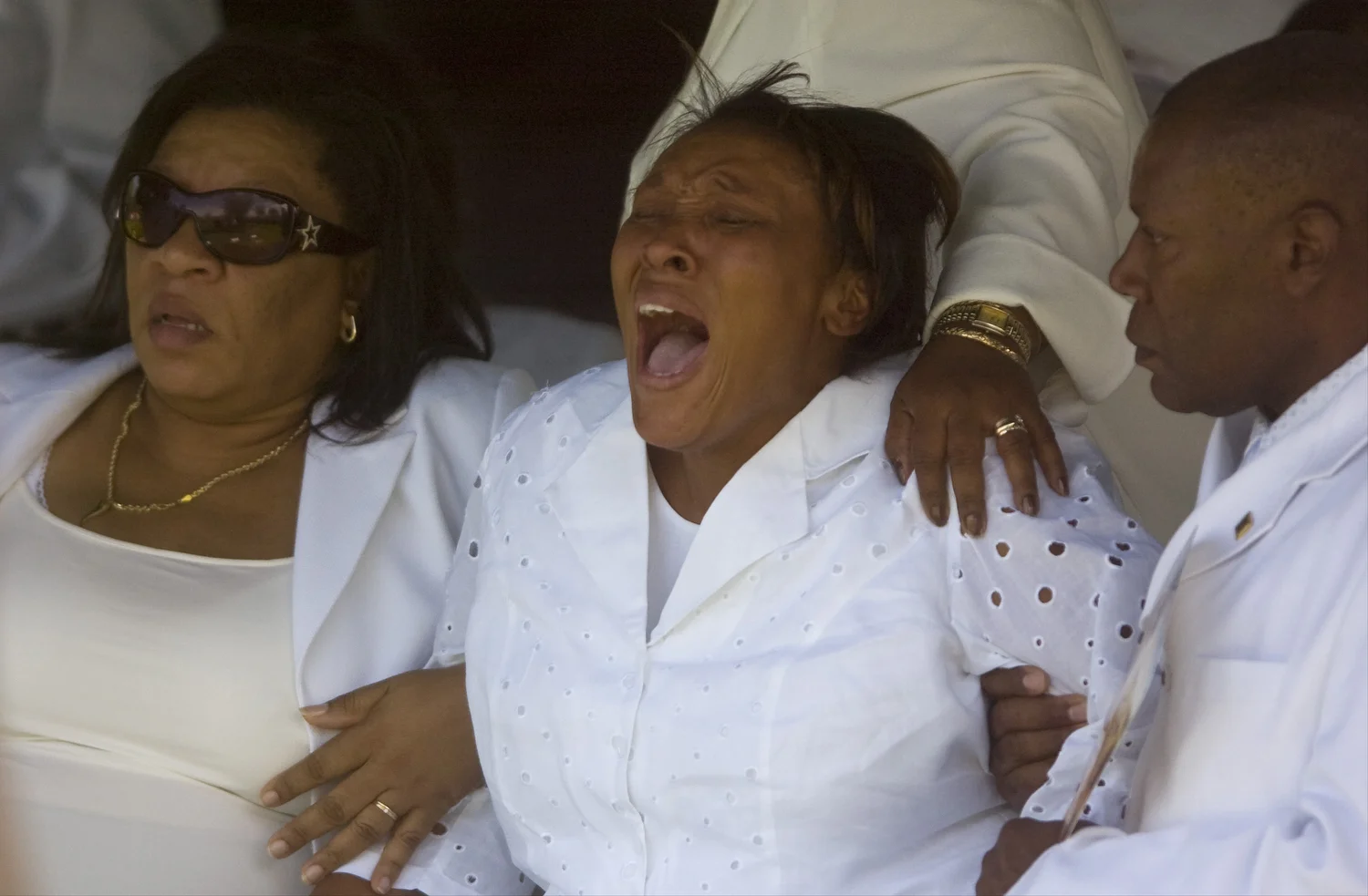  Netty Fleury is consoled by family during the graveside service of Guerline Dieu Damas and her children Meshach Zach, 9, Maven Isaak, 6, Marven Isaah, 5, Megan, 3, and Morgan, 19 months. Husband and father Mesac Damas is awaiting trial for their mur