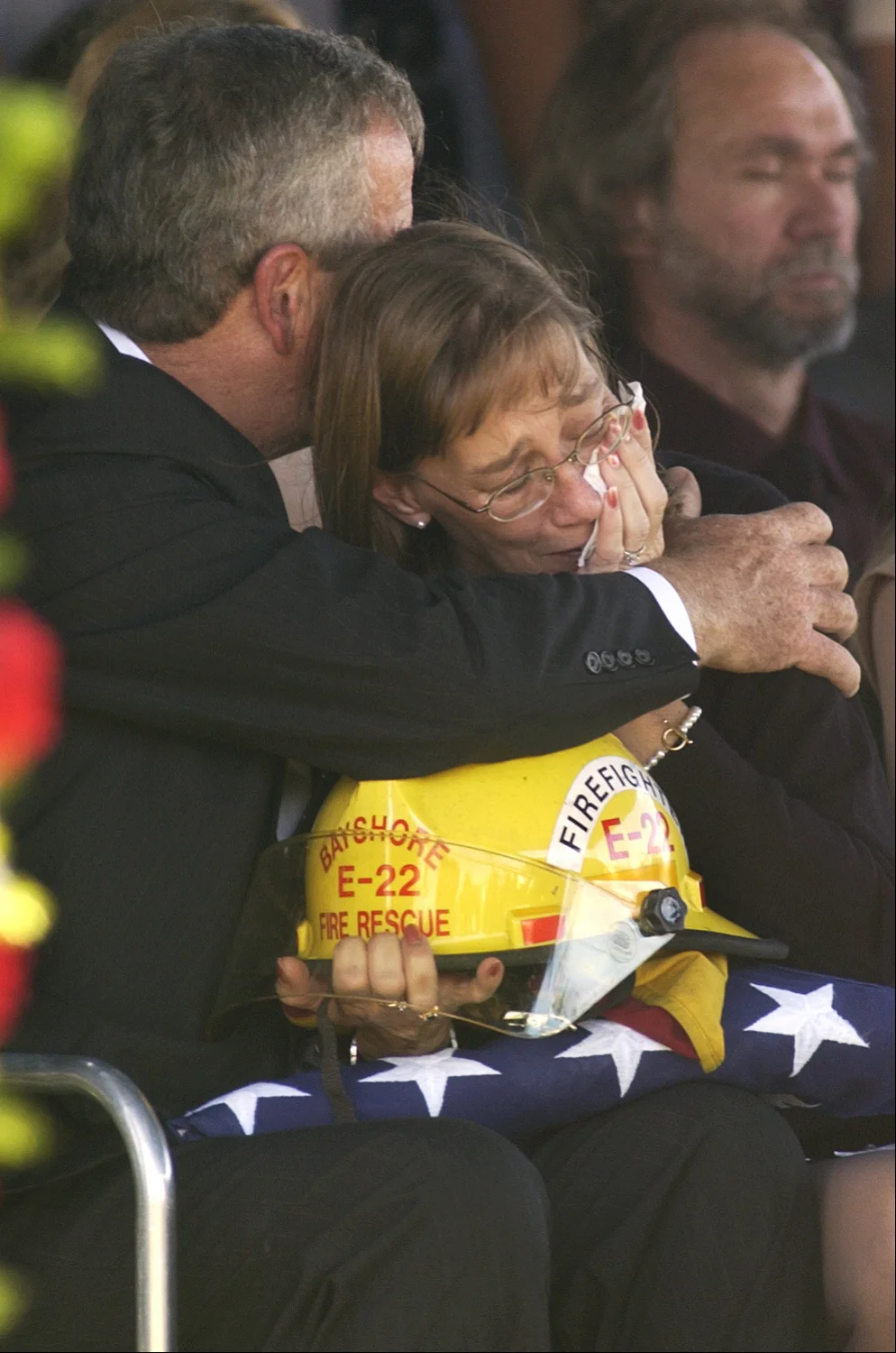  Jerry and Kathe Starks, the parents of Fort Myers Police Officer and former Bayshore firefighter Daniel Starks, embrace after they were given the flag and his fire helmet during the graveside service. Starks, who was on his first solo shift, was kil
