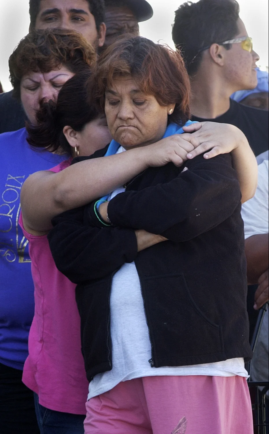  Mariscela Muniz, left, hugs her mother Luz Maria Gauna while they wait in line for water and ice in Belle Glade after Hurricane Wilma. The line for provisions was around the block, and many waited for hours.&nbsp;&nbsp;&nbsp;&nbsp;&nbsp;&nbsp;&nbsp;