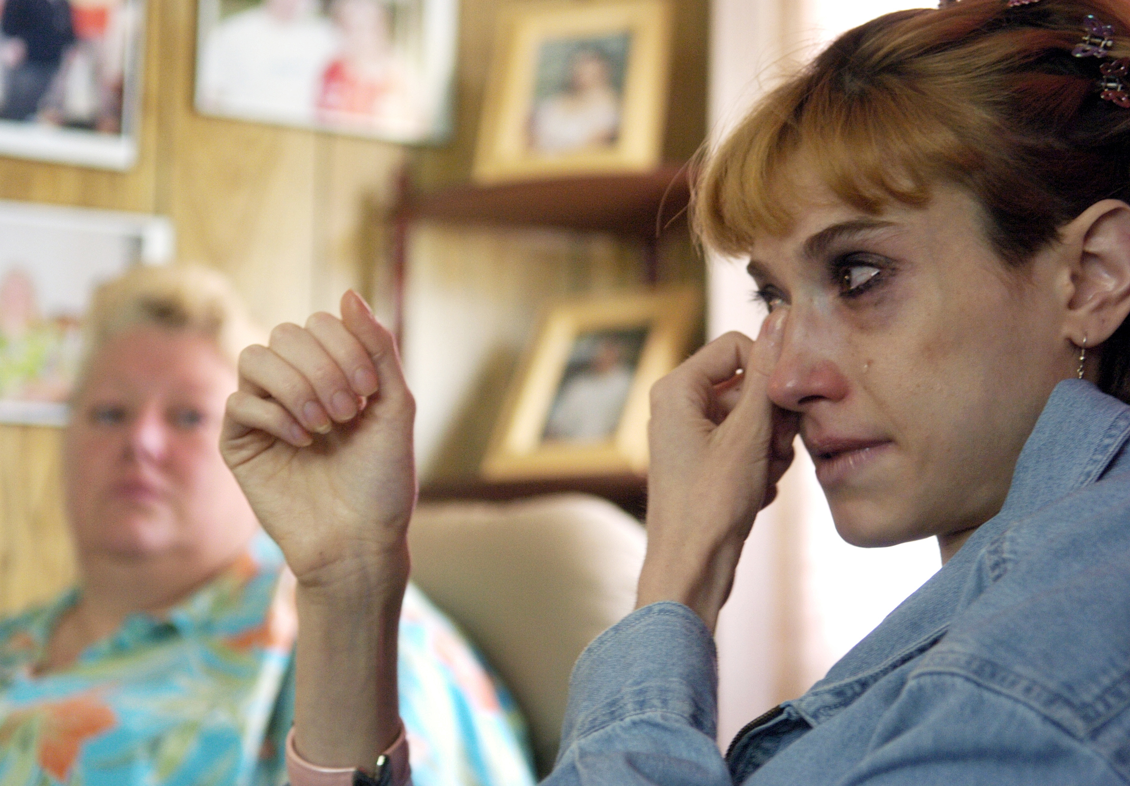 Melissa wipes tears from her face as Deanna looks on with concern. They had just found out that Melissa would have to return home to Colorado because Deanna wasn't sure if she could afford to continue living in her mobile home.