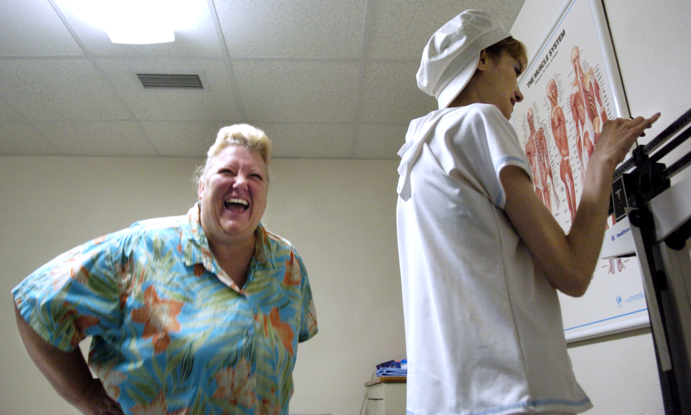 Deanna laughs at a comment made by Melissa during one of their weekly weigh-ins. While Deanna slowly lost weight, Melissa's weight fluctuated.