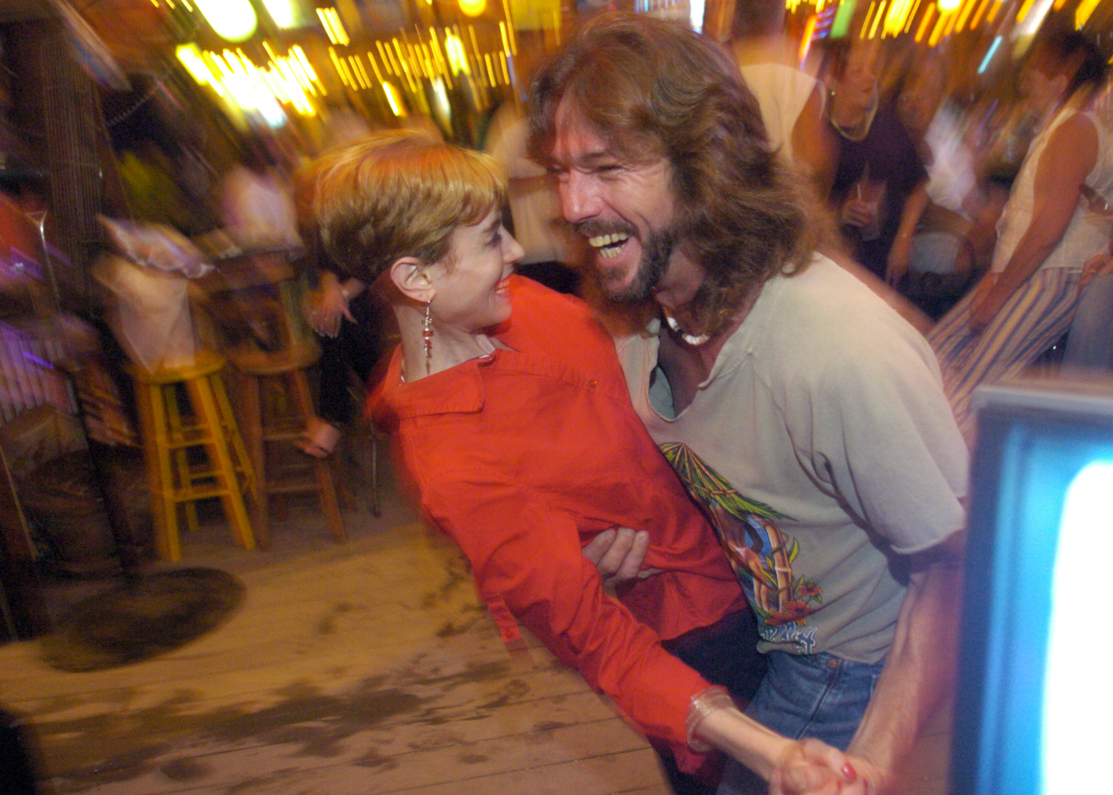 Melissa dances with an admirer at a karaoke bar on their last night before Melissa went home to Colorado. She eventually recovered and found work at an eating disorder clinic.