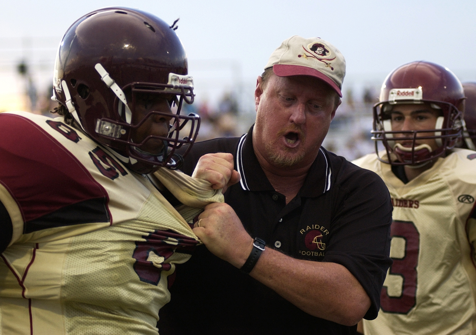 Coach Scott Jones grabs Terrence Cody on the sidelines during Riverdale's exhibition game at Charlotte High School. Jones is like a father figure to many on the team, and he has coached most of the seniors since they were sophomores.