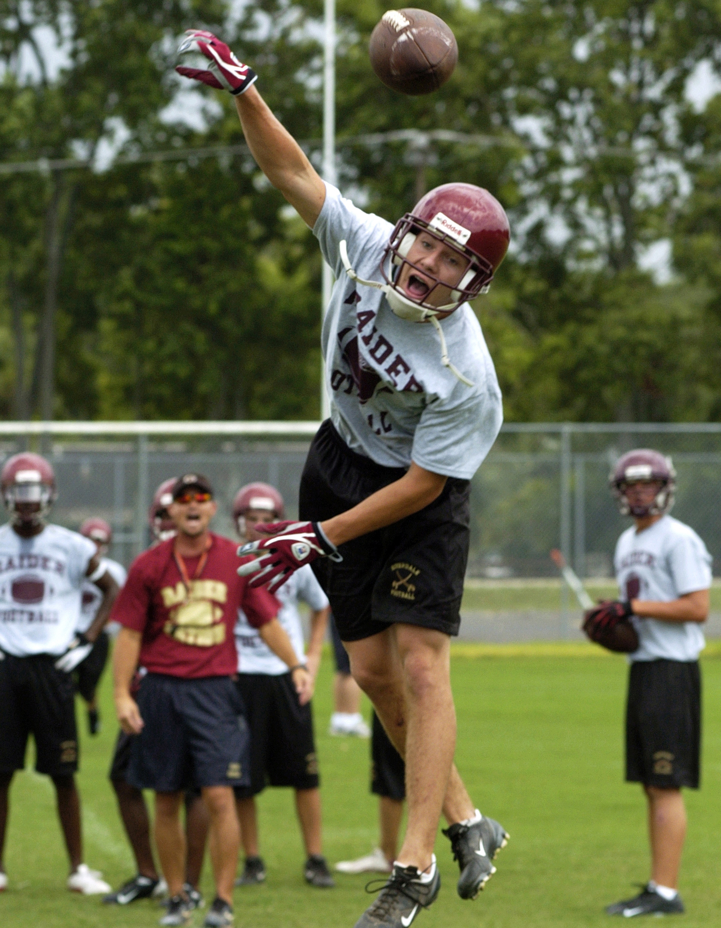 Jordan Holland jumps for the ball during a drill at Riverdale's first practice of the season. The team had just returned from a week of training in West Virginia.
