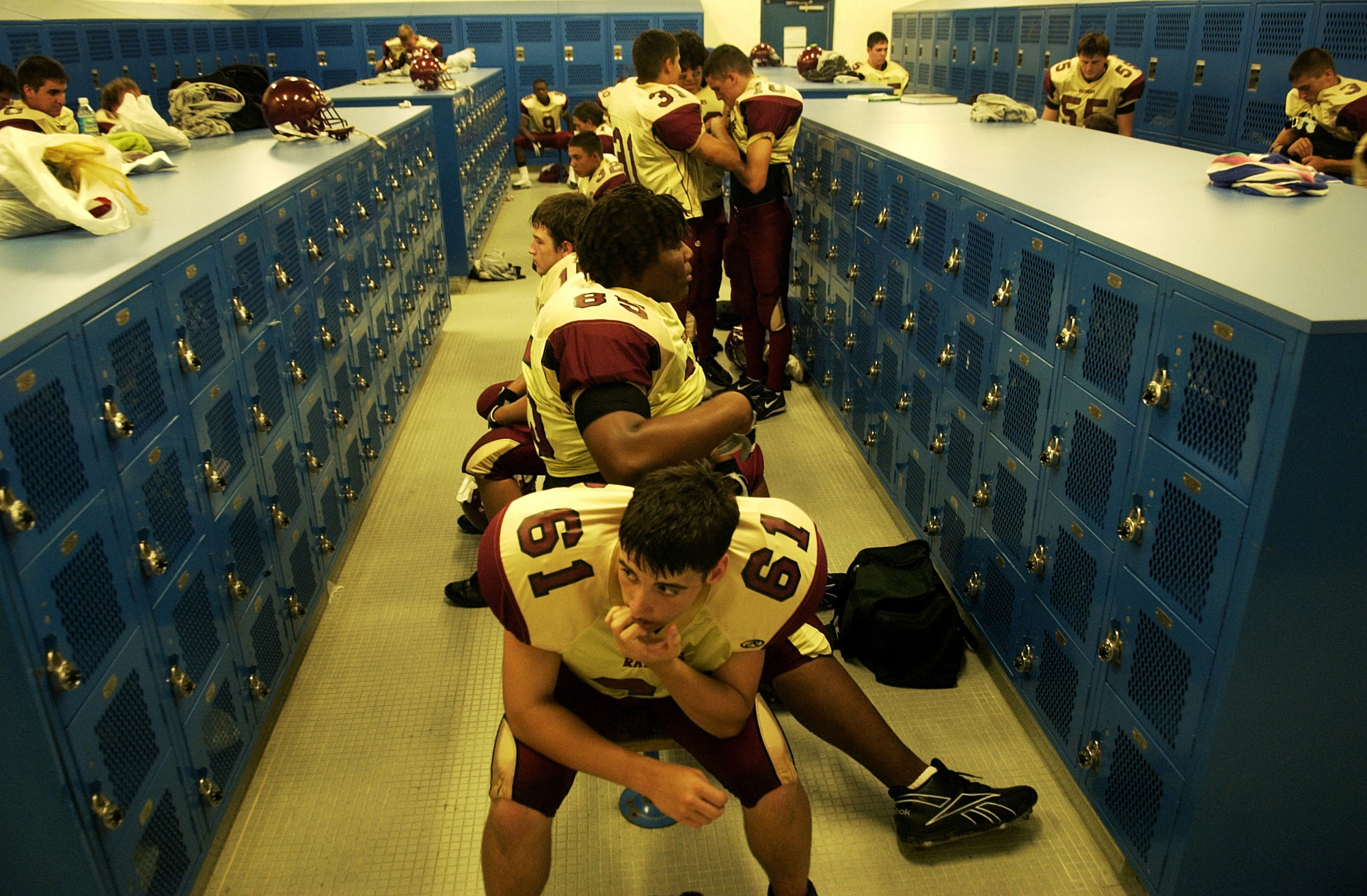 Josh Owens, center, and his teammates prepare for their game at Charlotte High School at the beginning of the season. The game was Charlotte's first game in their stadium since it was damaged by Hurricane Charley.