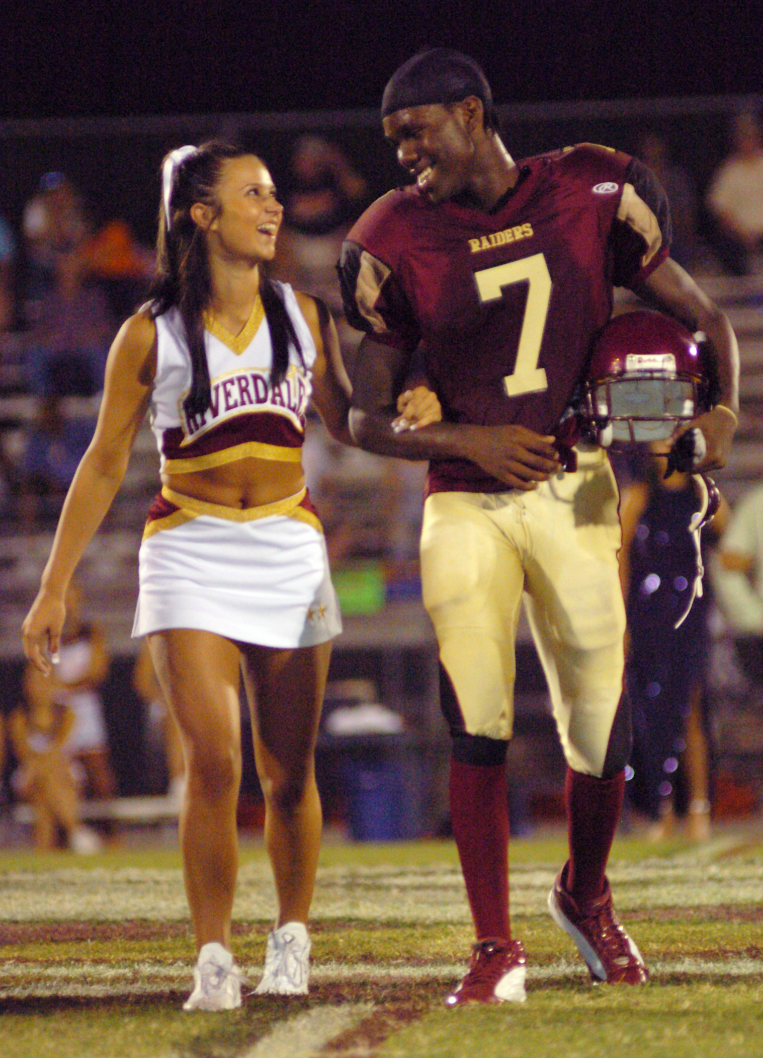 Riverdale Homecoming Queen and King candidates Lynae Prout and Jarvis Williams laugh as they cross the field at halftime. Williams was crowned king.