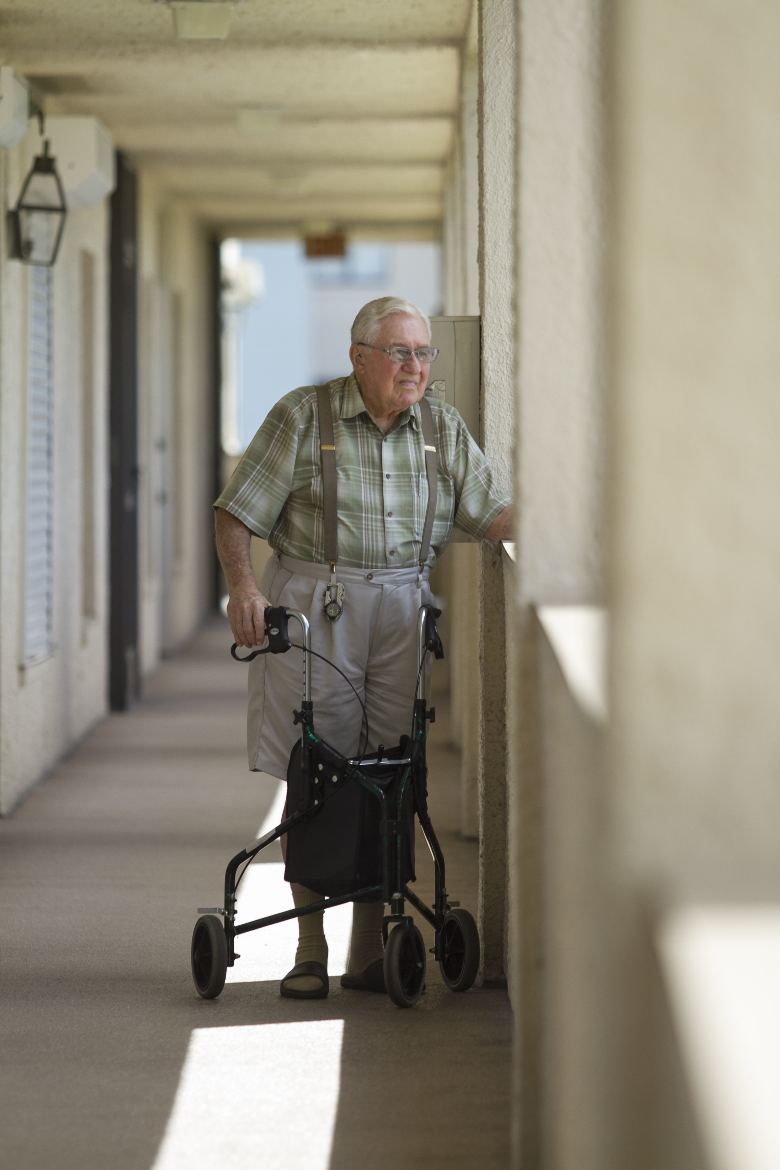  Joe Pre-Genzer looks out over the parking lot at the south Fort Myers condo he shares with his wife Kate. Since he was diagnosed with Alzheimer's, he has had to give up driving and goes everywhere with Kate, preferring not to be alone. 